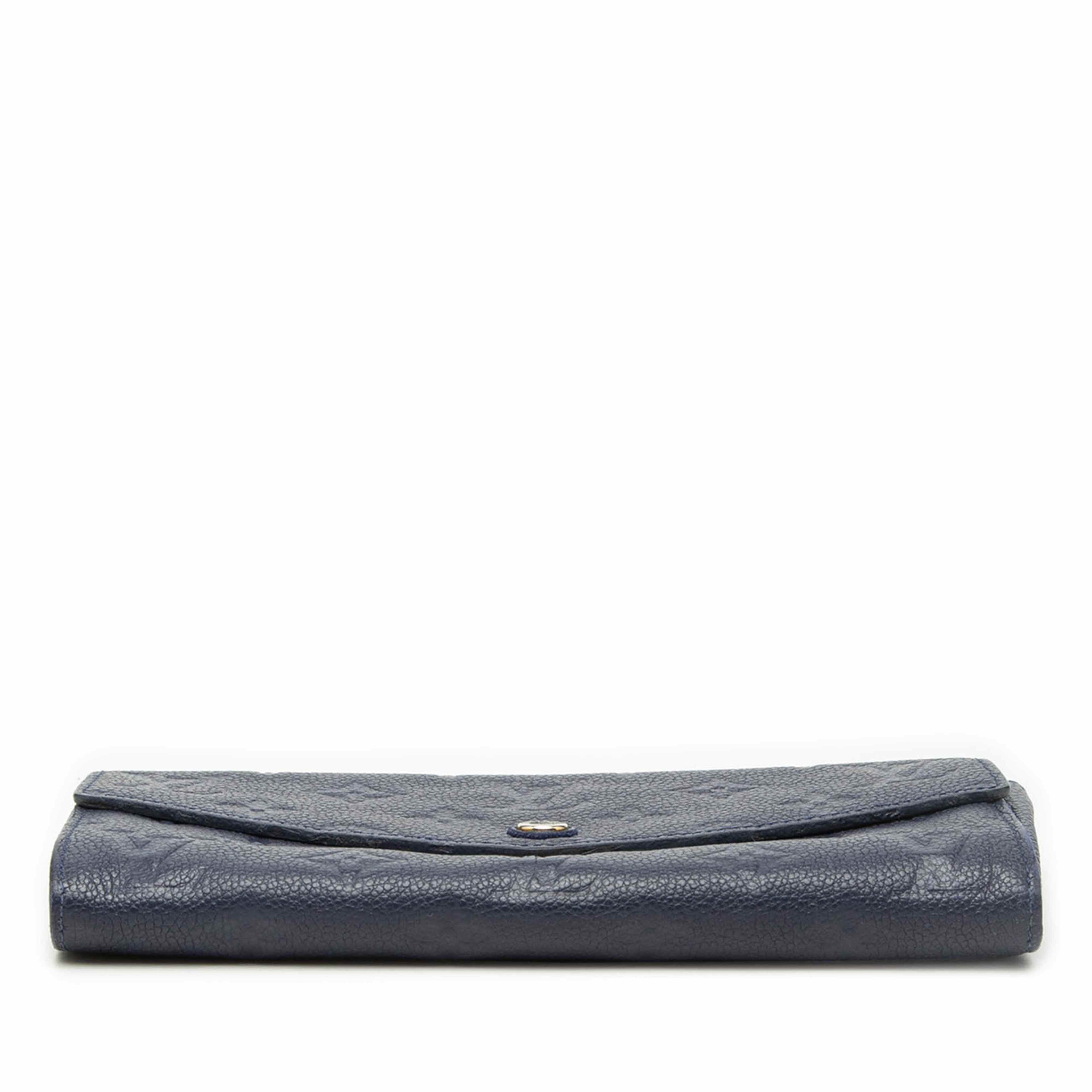 Louis Vuitton Monogram Empreinte Curieuse Wallet, från Luxclusif, i färgen navy. Klicka för att öppna bilden i stort format
