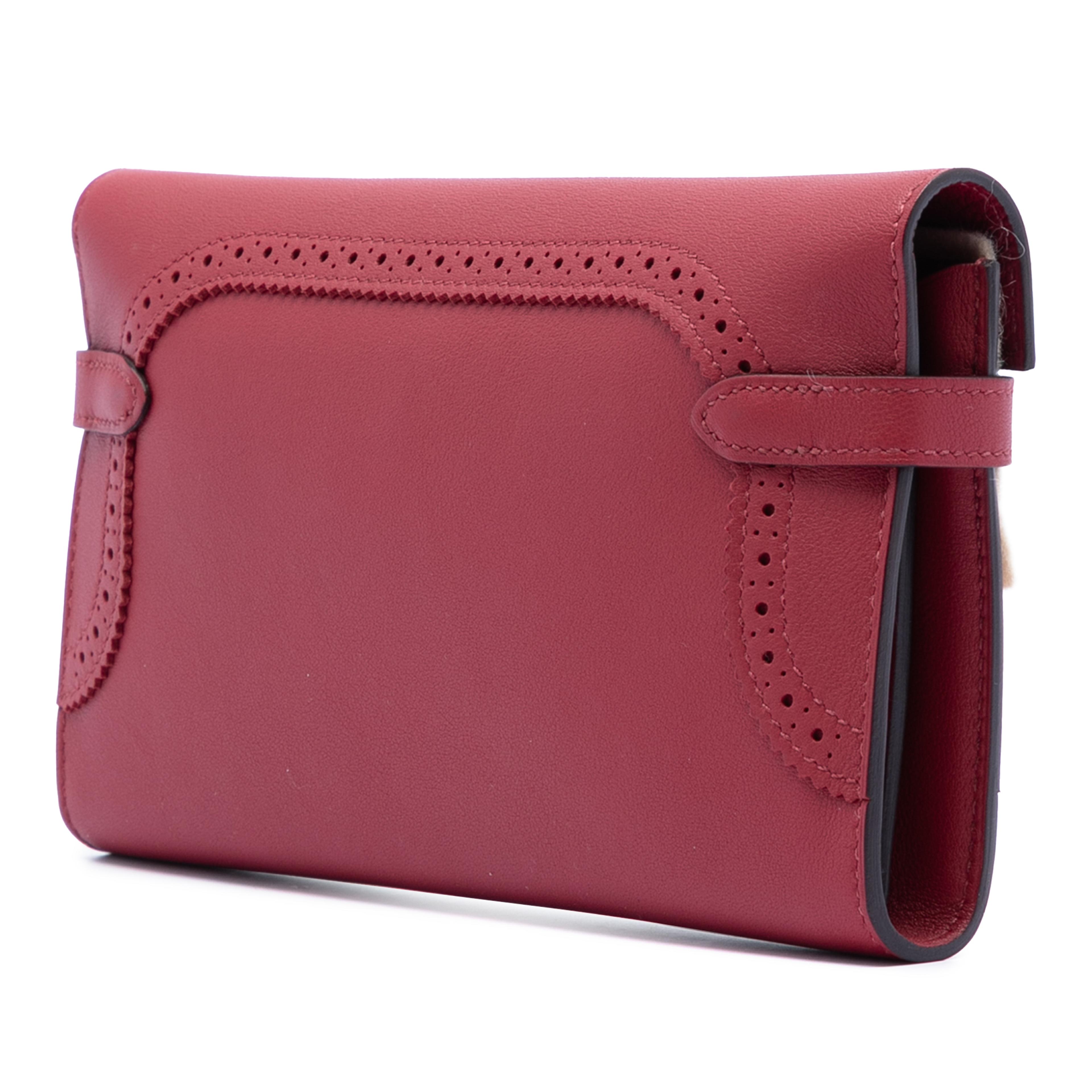 Hermès Swift Ghillies Kelly Longue Wallet, från Luxclusif, i färgen dark red. Klicka för att öppna bilden i stort format