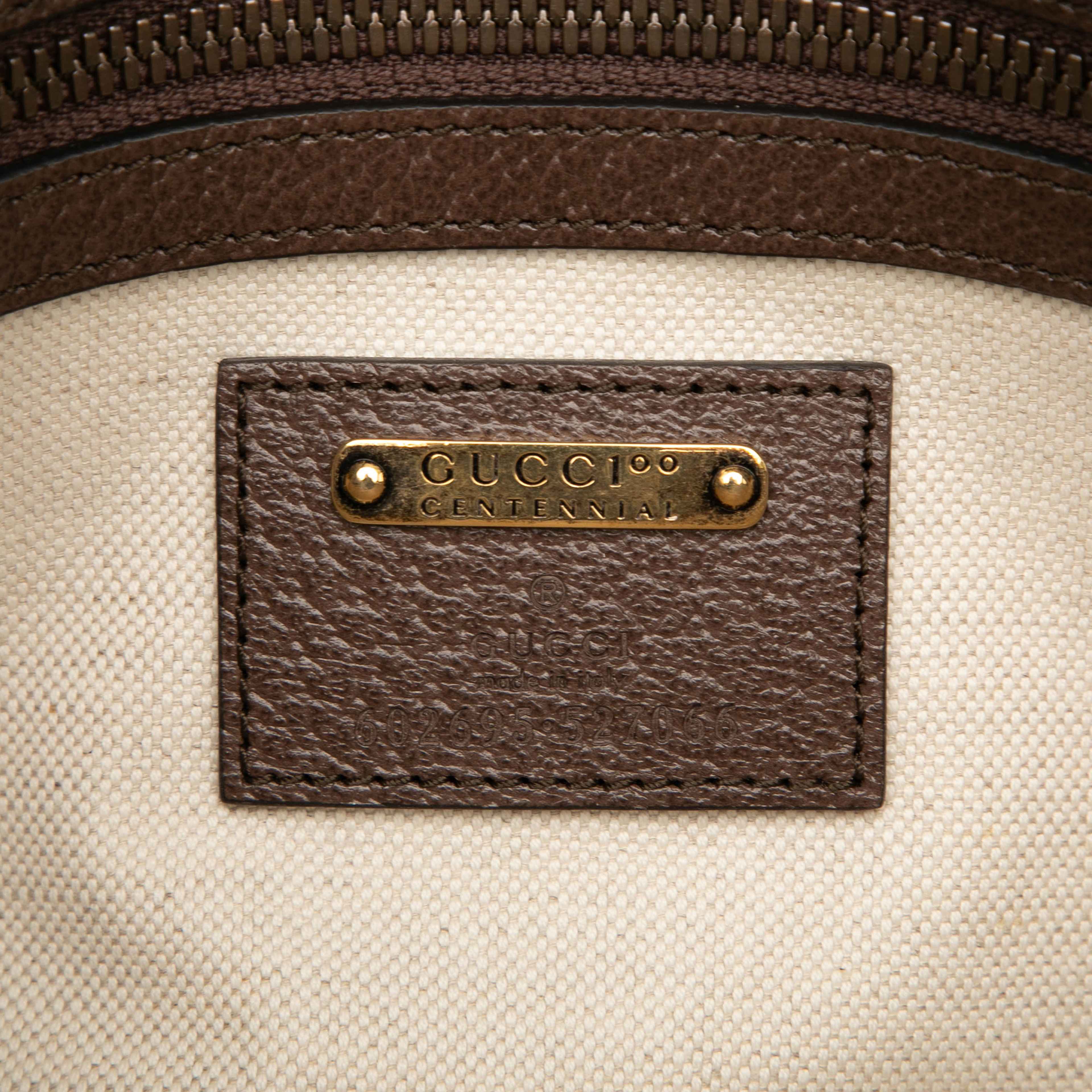 Gucci 100th Anniversary Textured Dollar Calfskin Logo Belt Bag, från Luxclusif, i färgen dark brown. Klicka för att öppna bilden i stort format