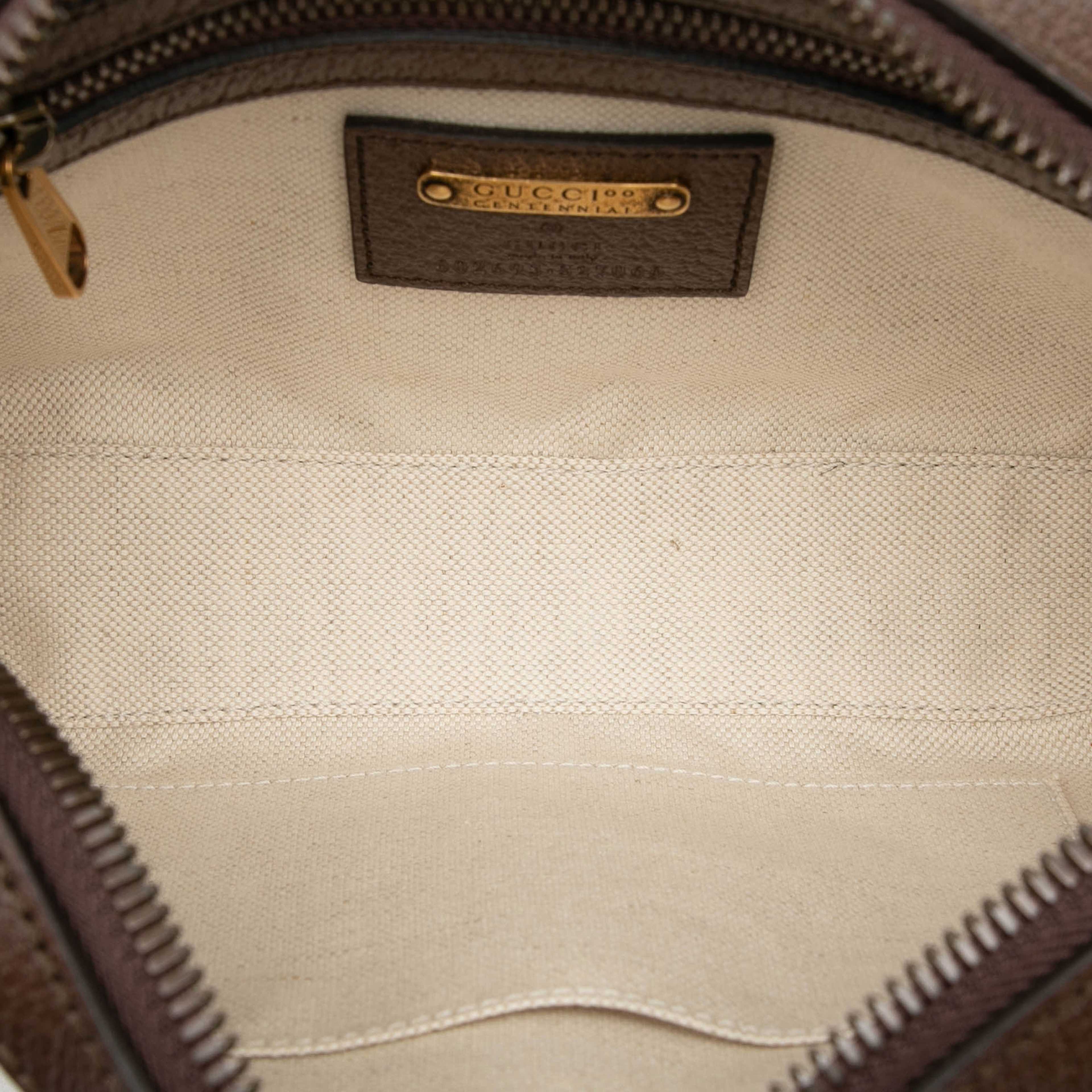 Gucci 100th Anniversary Textured Dollar Calfskin Logo Belt Bag, från Luxclusif, i färgen dark brown. Klicka för att öppna bilden i stort format