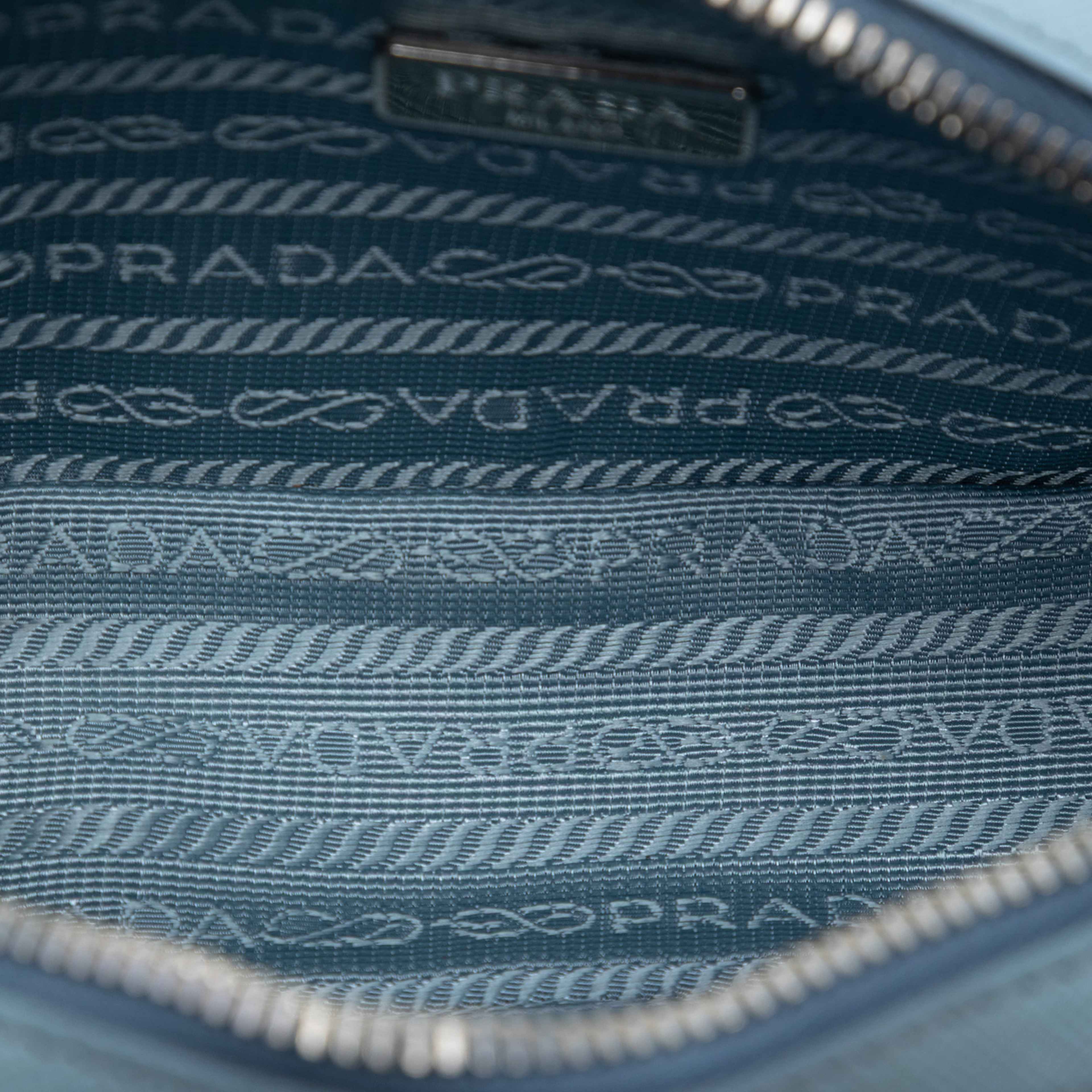 Prada Mini Saffiano Camera Bag, från Luxclusif, i färgen light blue. Klicka för att öppna bilden i stort format
