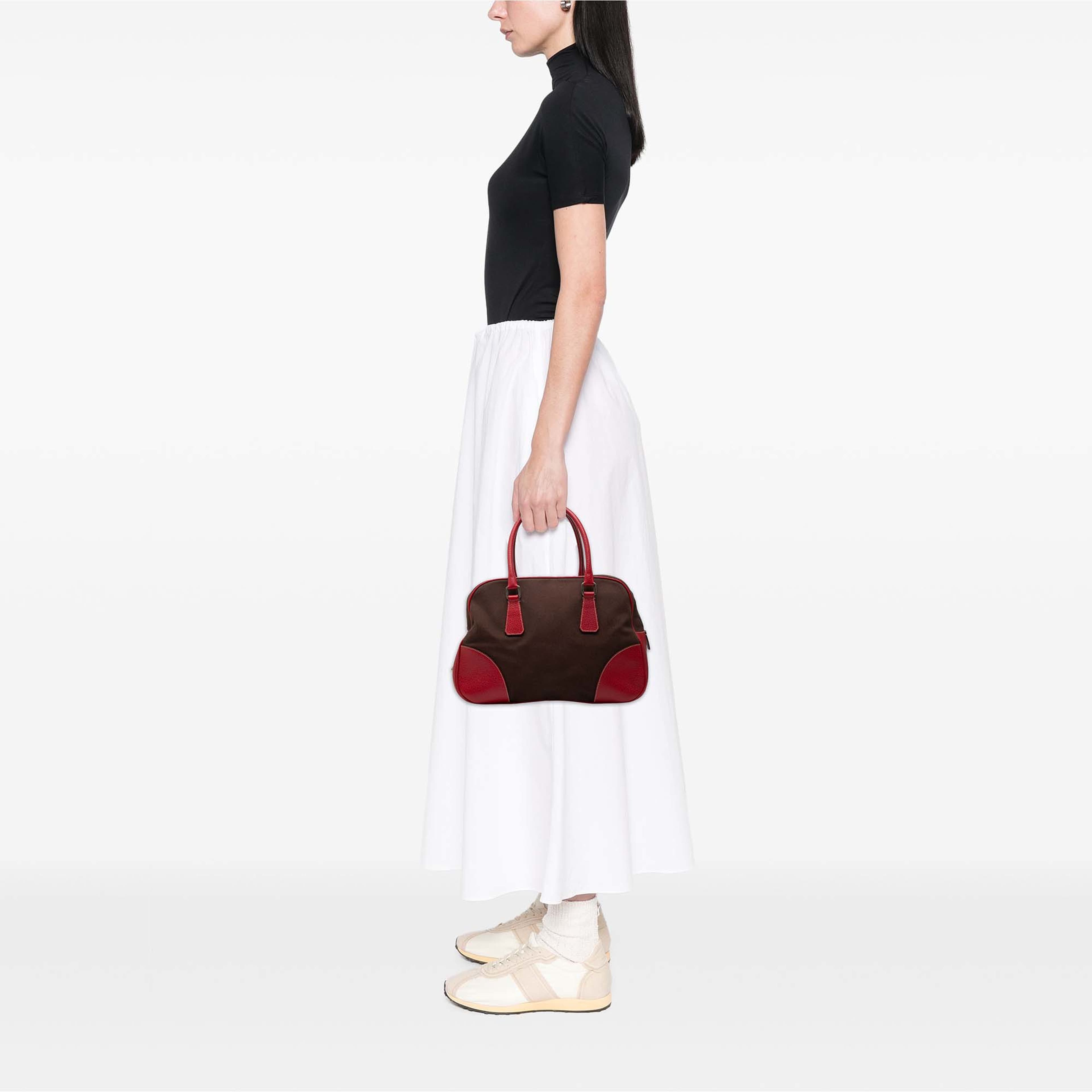 Prada Cinghiale Trimmed Canvas Canapa Bauletto Bag, från Luxclusif, i färgen brun. Klicka för att öppna bilden i stort format