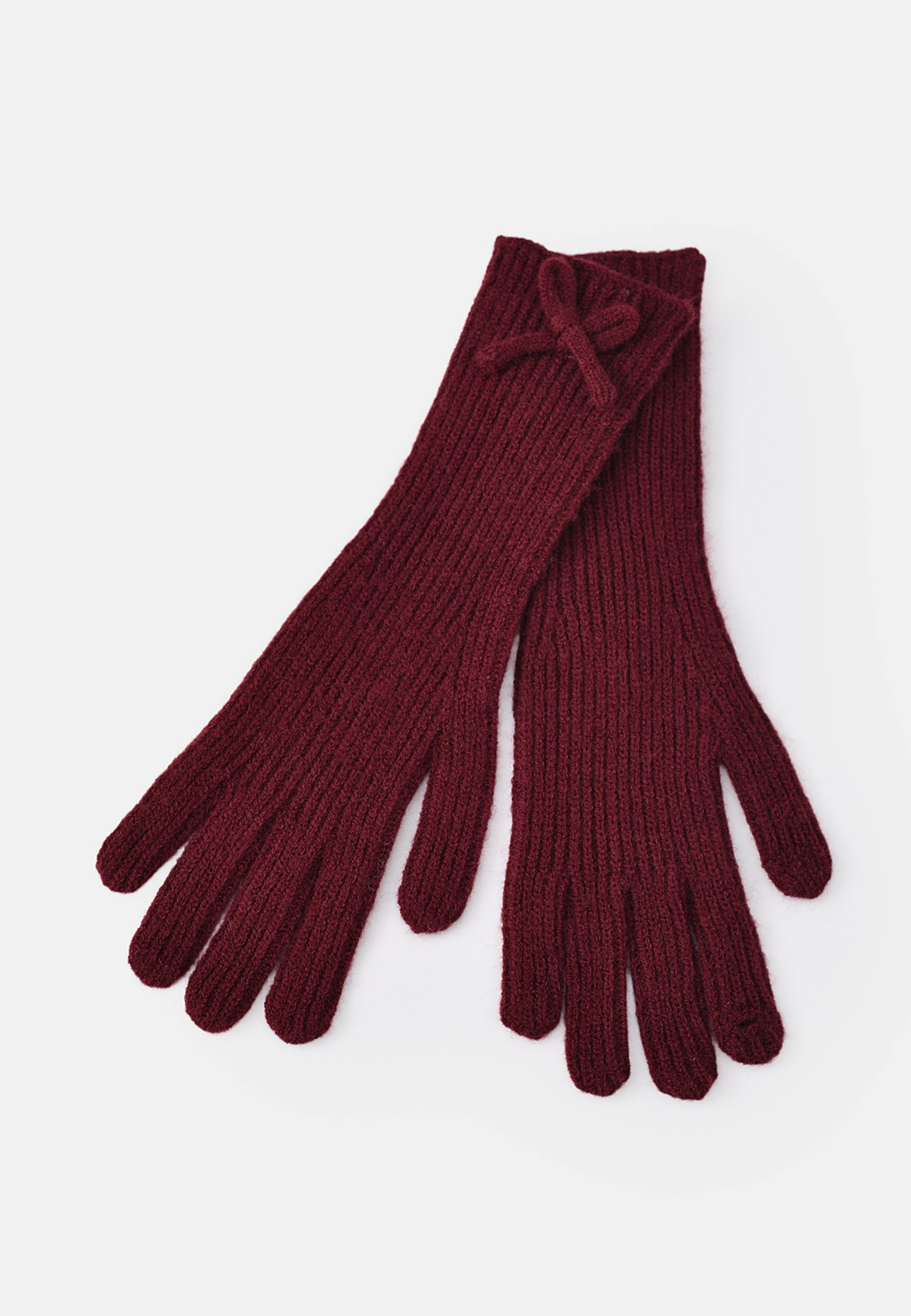 Fingervantar med rosett SAGA, från Å WOMAN, i färgen Wine Red. Klicka för att öppna bilden i stort format