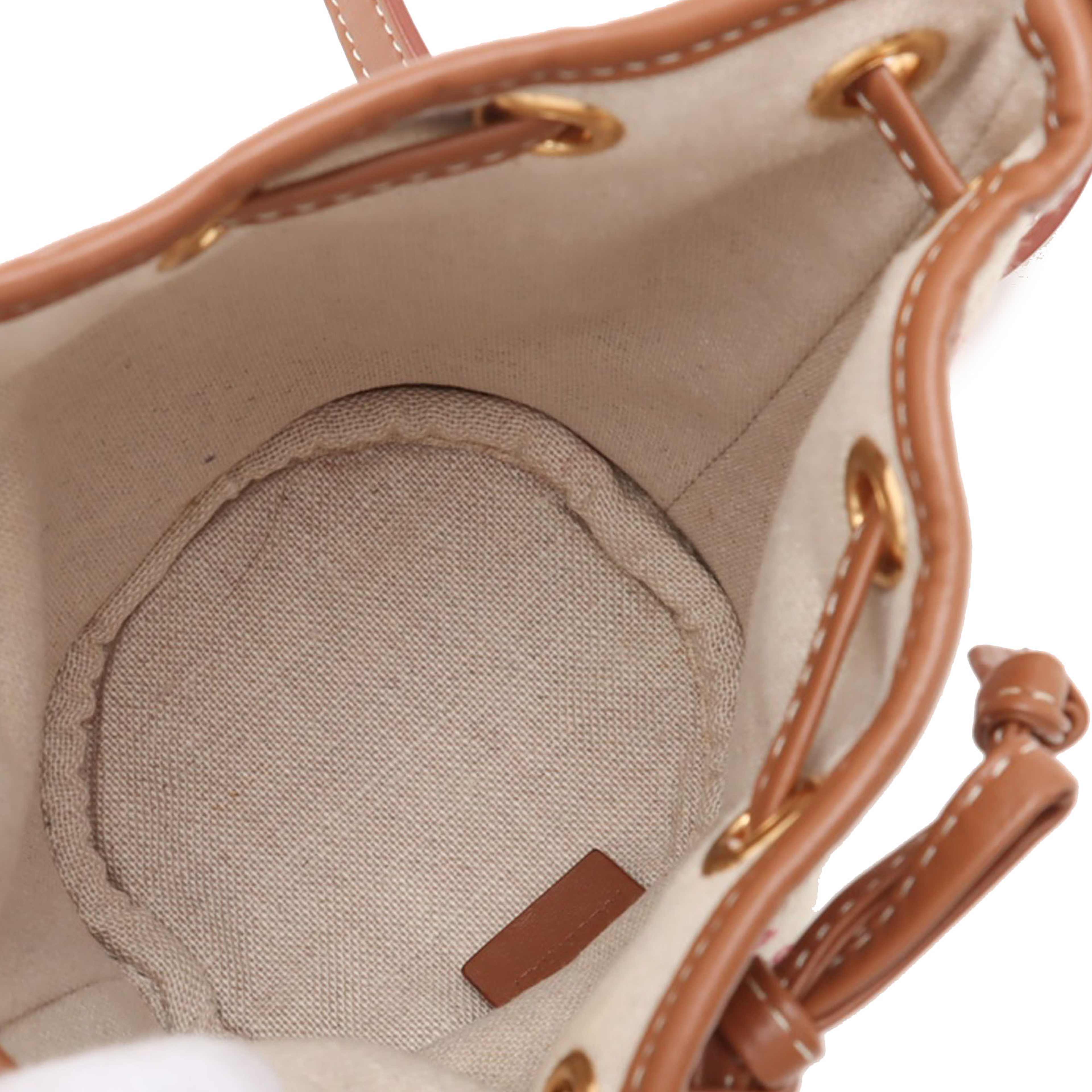 Celine Micro Triomphe Embroidered Canvas Drawstring Bucket Bag, från Luxclusif, i färgen beige. Klicka för att öppna bilden i stort format