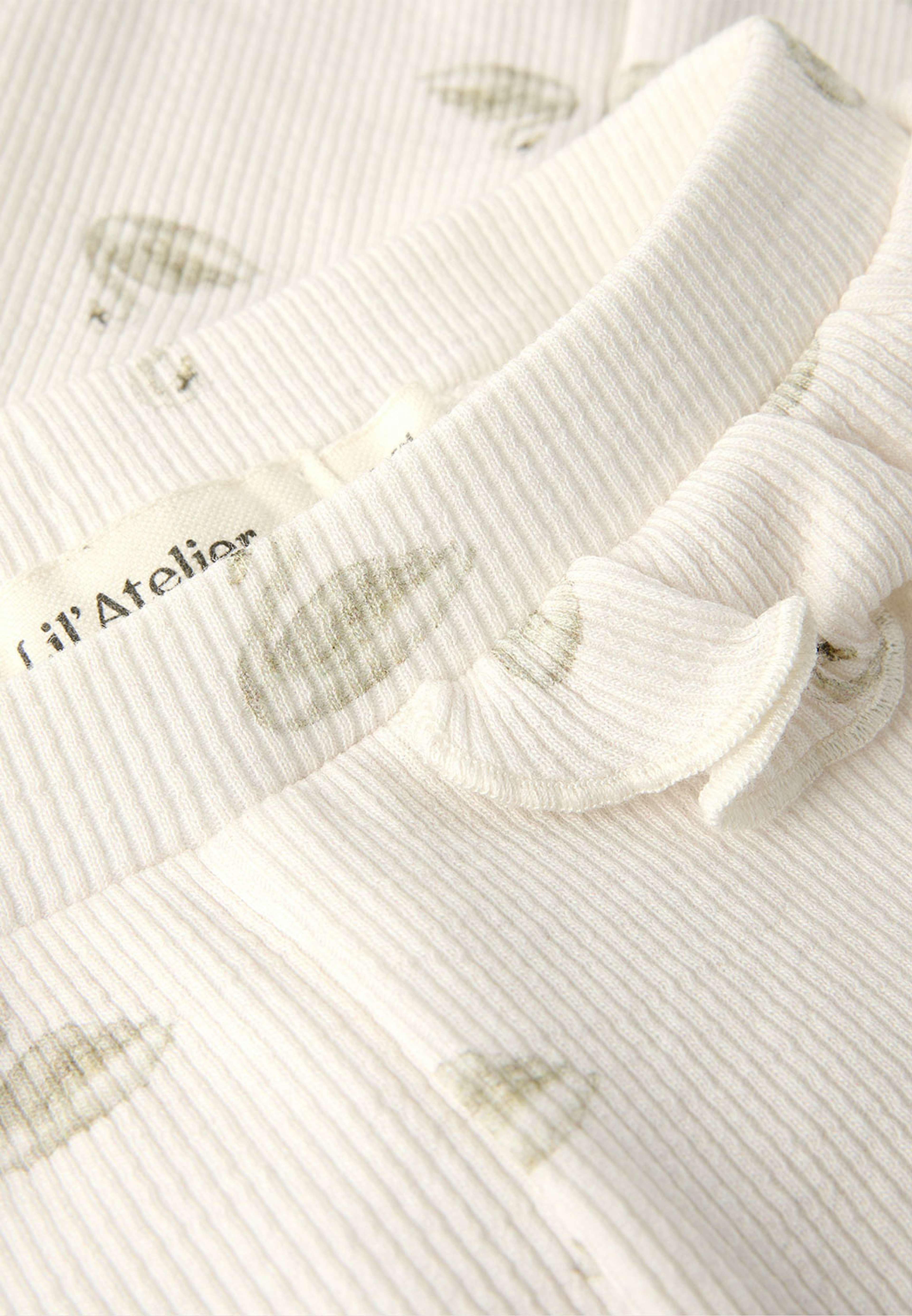 Gavo slim leggings, från Lil'Atelier, i färgen Pastel Parchment Swan. Klicka för att öppna bilden i stort format