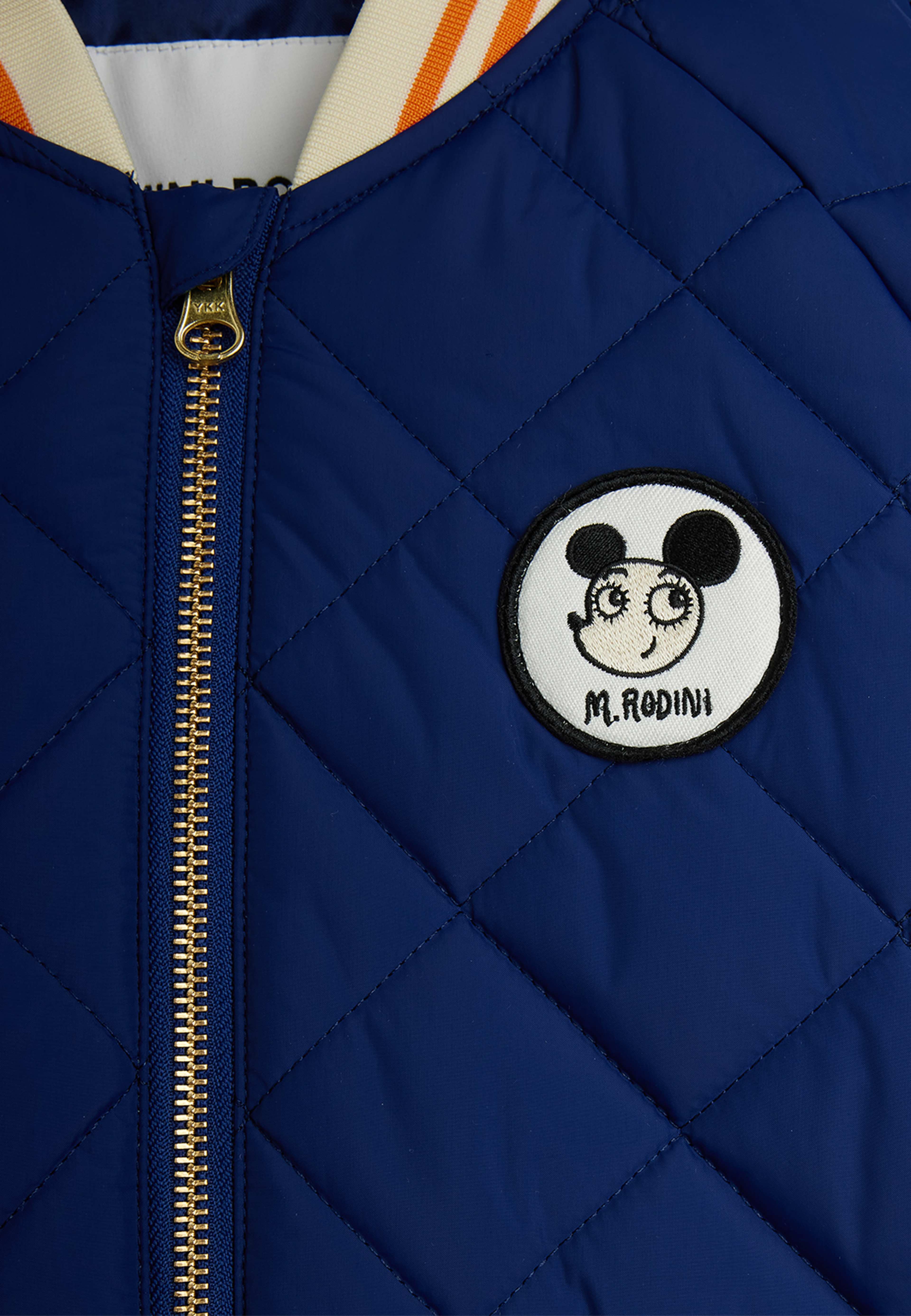 Ritzratz patch quilted puffer, från Mini Rodini, i färgen Blue. Klicka för att öppna bilden i stort format