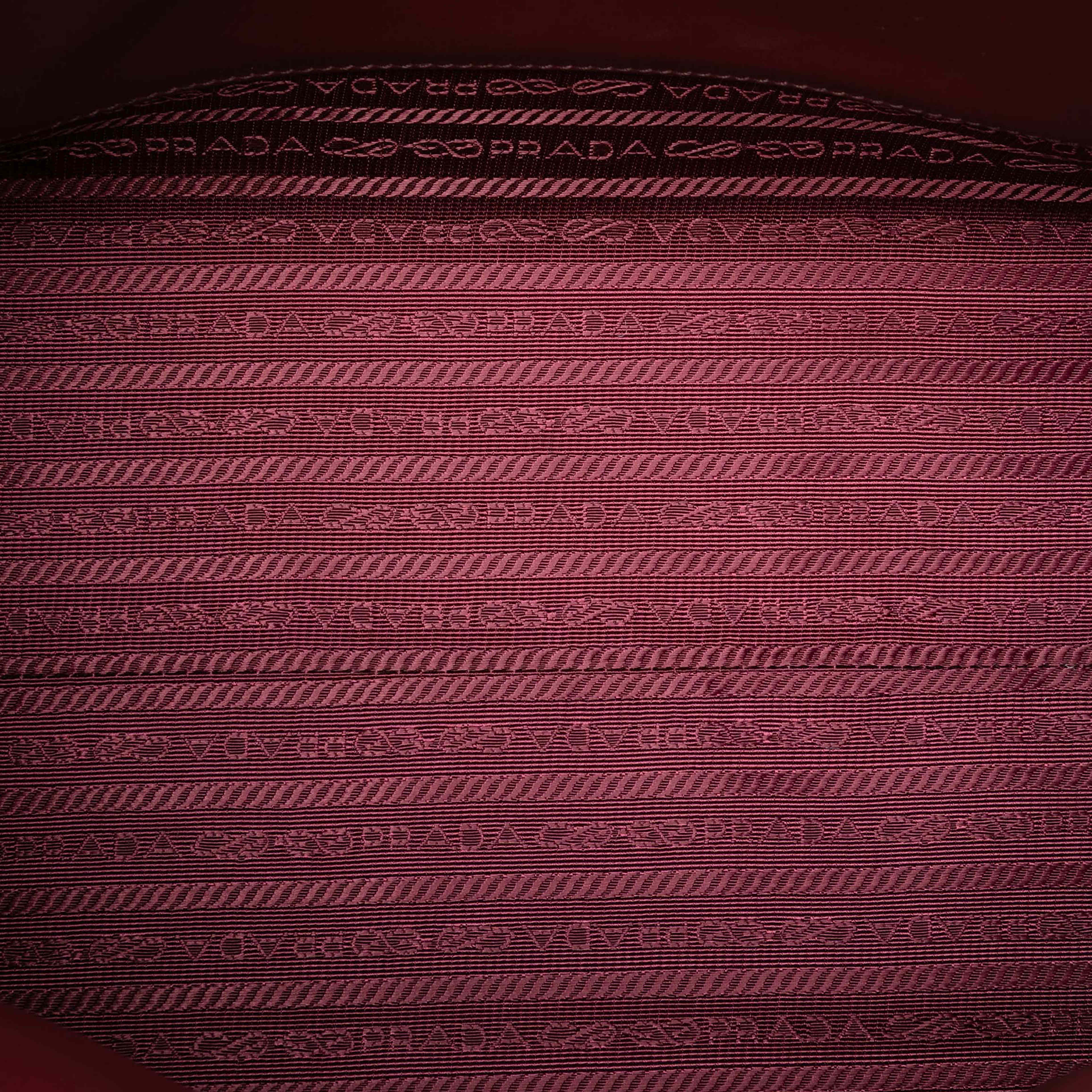 Prada Medium Saffiano Cuir Monochrome Top Handle Tote, från Luxclusif, i färgen burgundy. Klicka för att öppna bilden i stort format