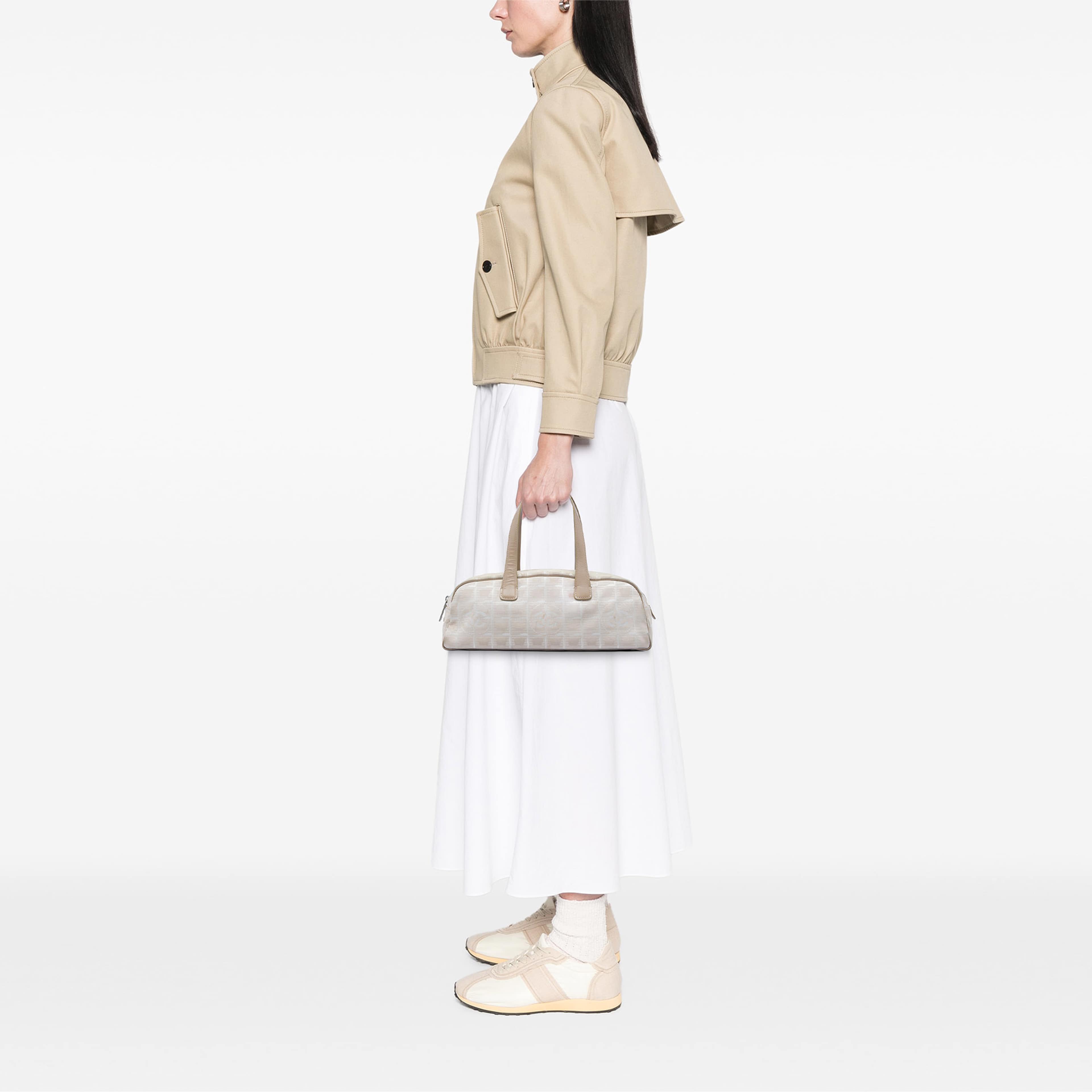 Chanel New Travel Line Nylon Handbag, från Luxclusif, i färgen beige. Klicka för att öppna bilden i stort format