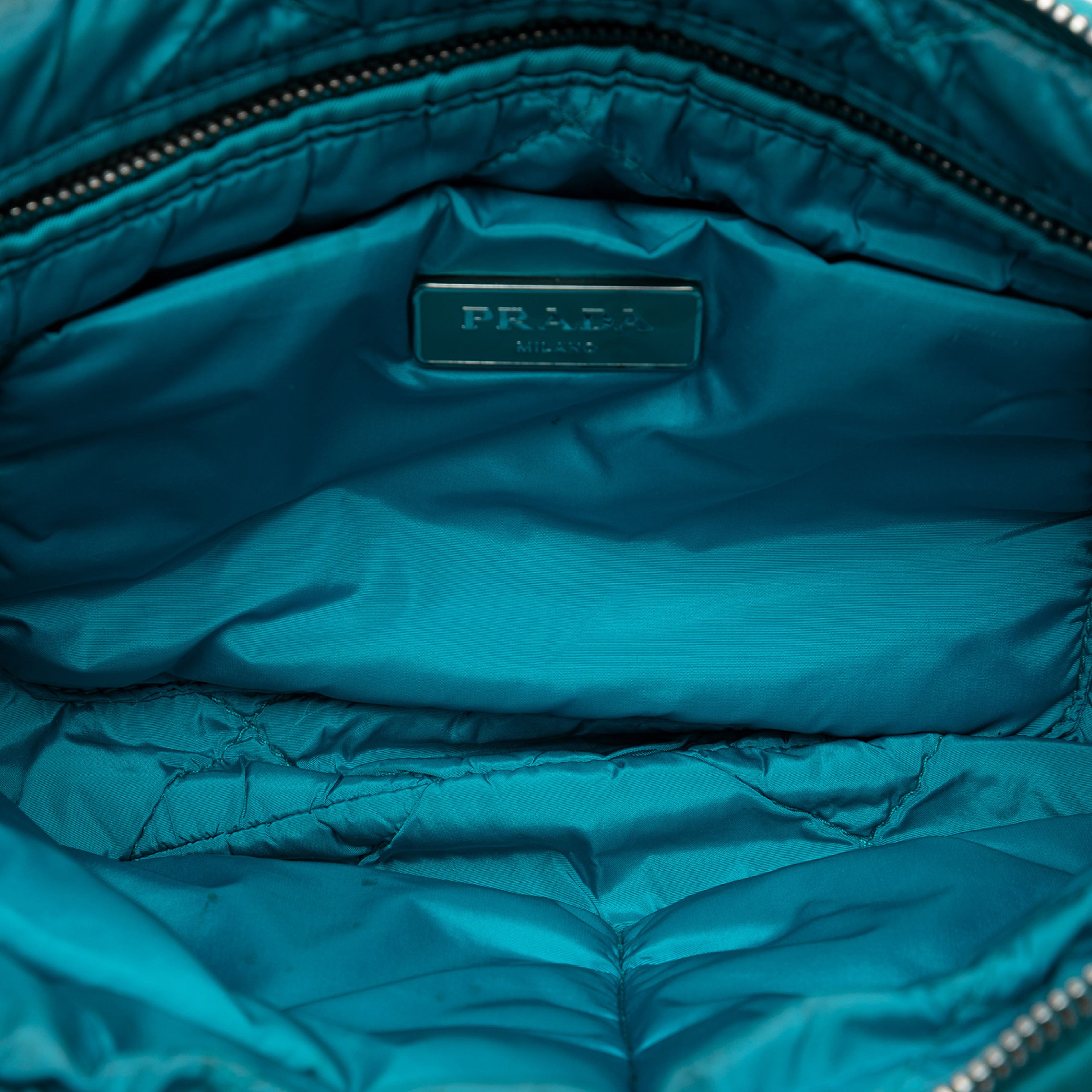 Prada Tessuto Bomber Clutch, från Luxclusif, i färgen turquoise. Klicka för att öppna bilden i stort format
