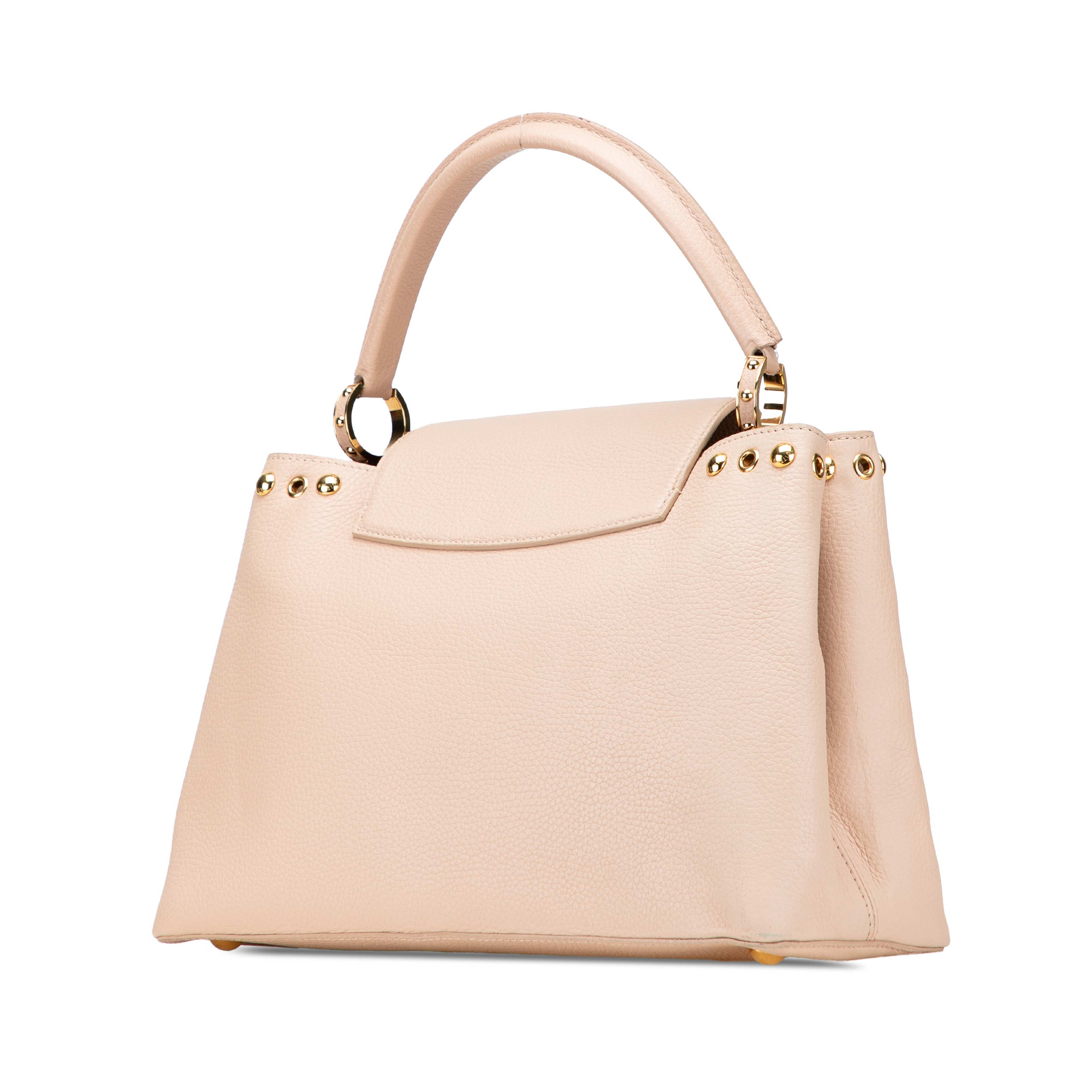 Louis Vuitton Taurillon Studdy Capucines Mm, från Luxclusif, i färgen beige. Klicka för att öppna bilden i stort format