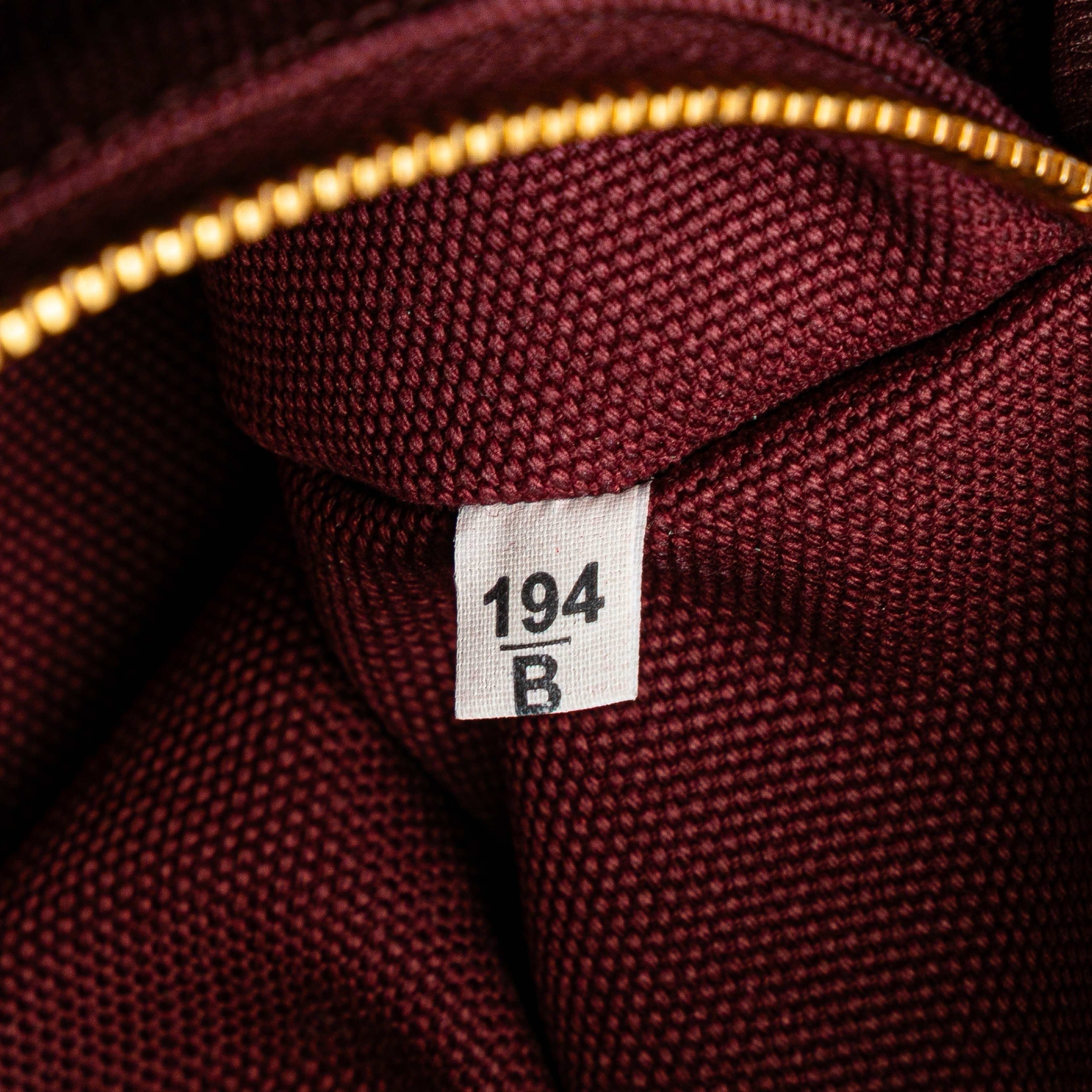 Prada Large Canvas Canapa Logo Satchel, från Luxclusif, i färgen burgundy.