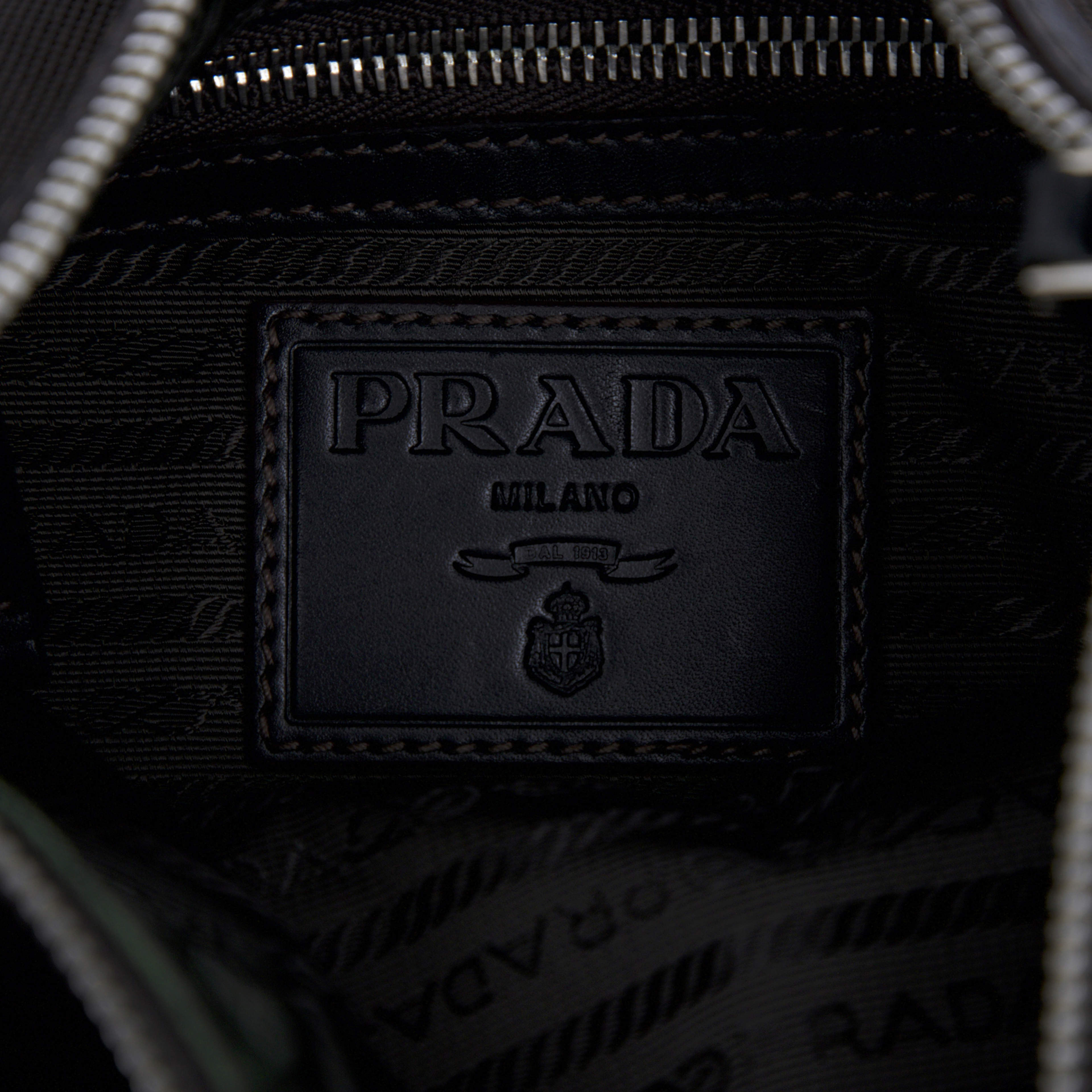 Prada Canvas Canapa Logo Crossbody, från Luxclusif, i färgen dark brown. Klicka för att öppna bilden i stort format