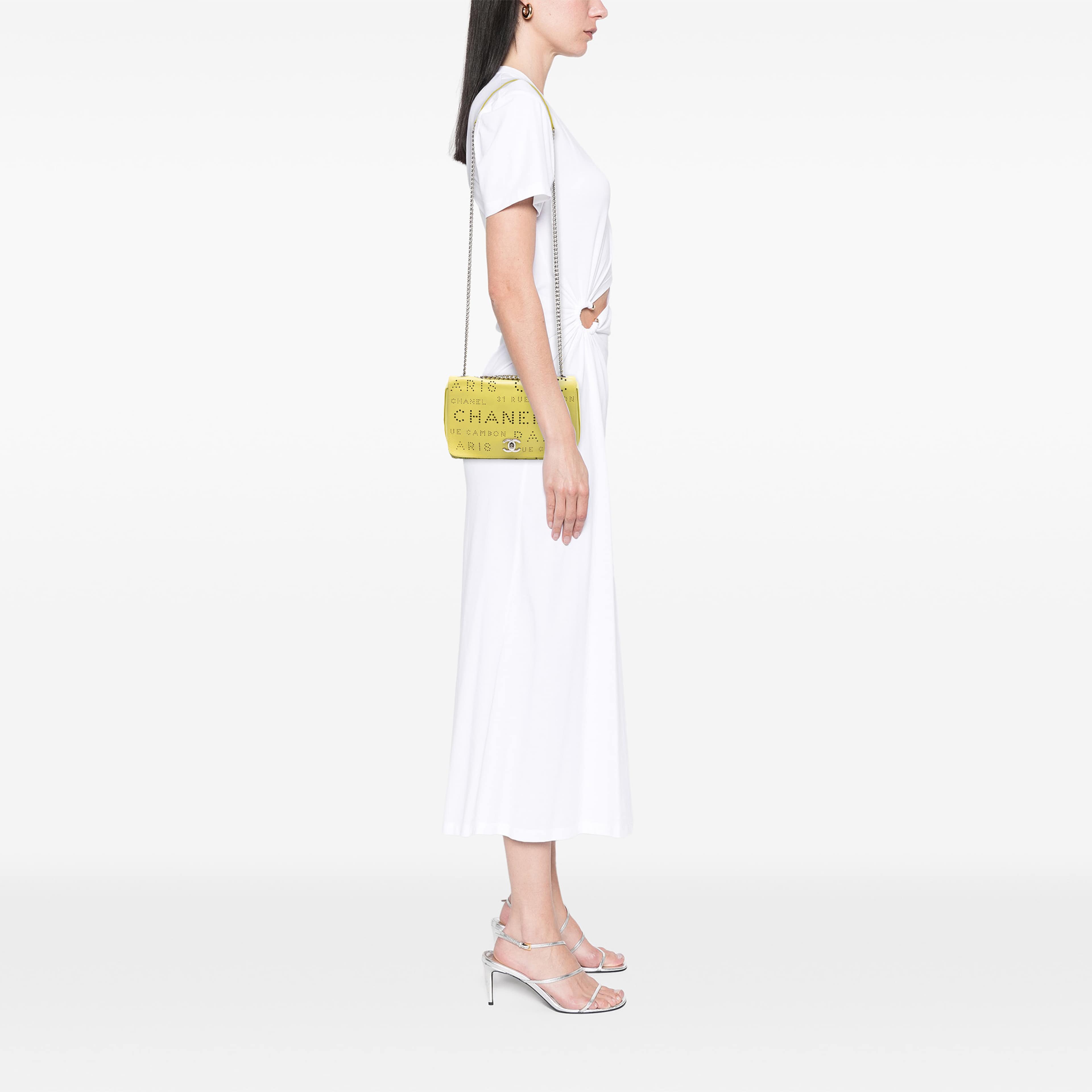 Chanel Perforated Calfskin Logo Eyelet Flap, från Luxclusif, i färgen gul. Klicka för att öppna bilden i stort format