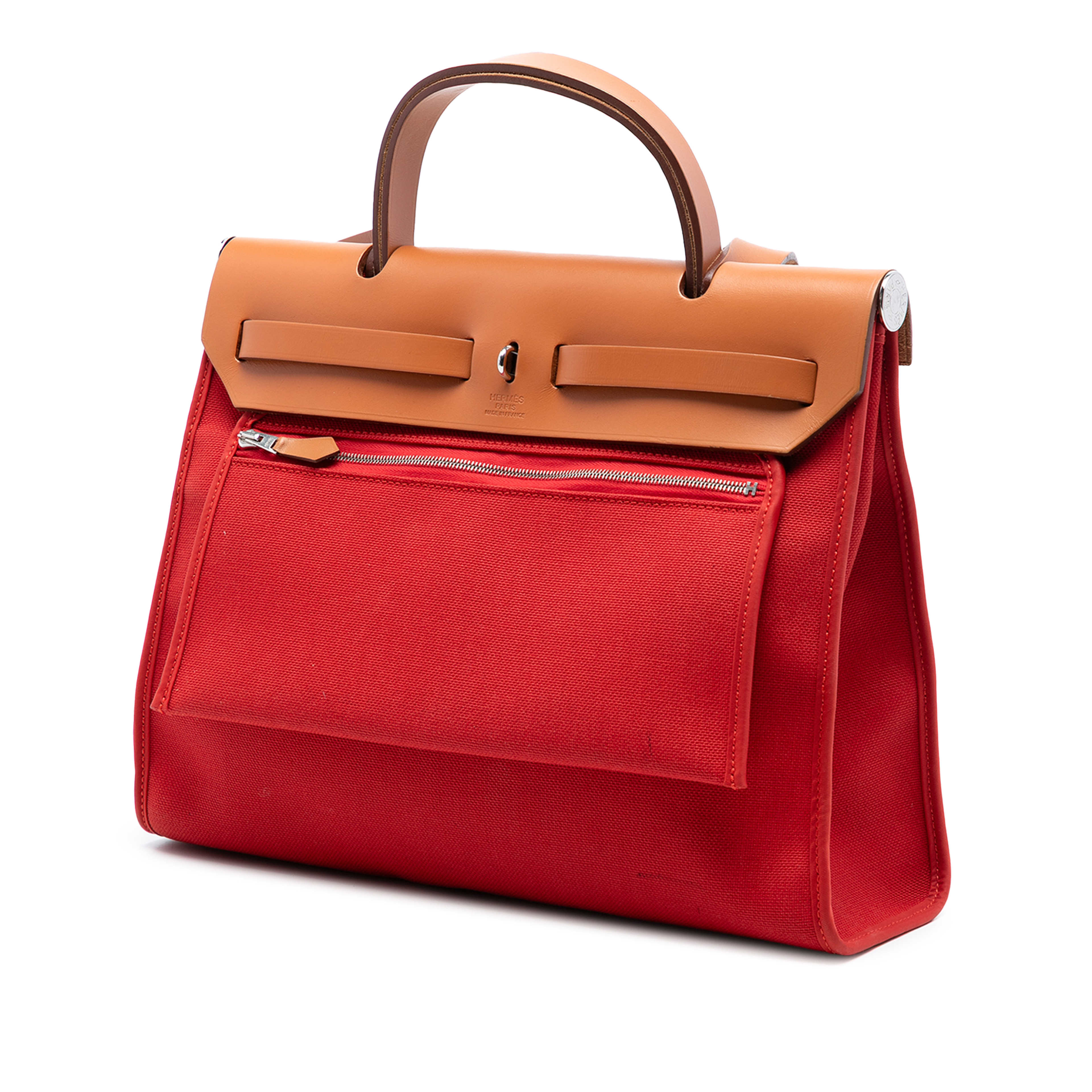 Hermès Toile Herbag Zip 31, från Luxclusif, i färgen red orange. Klicka för att öppna bilden i stort format
