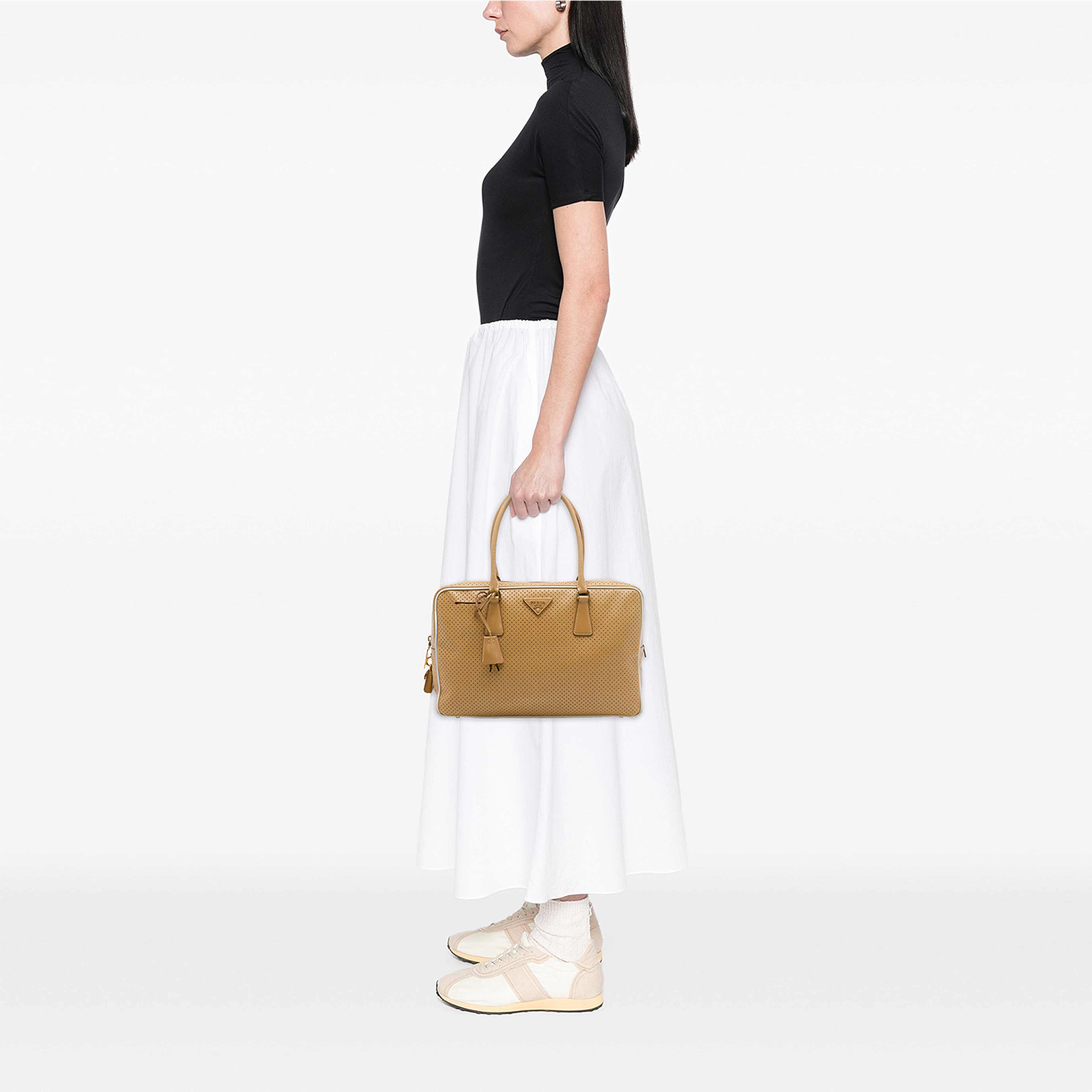 Prada Perforated Saffiano Lux Bauletto Top Handle Bag, från Luxclusif, i färgen brun. Klicka för att öppna bilden i stort format