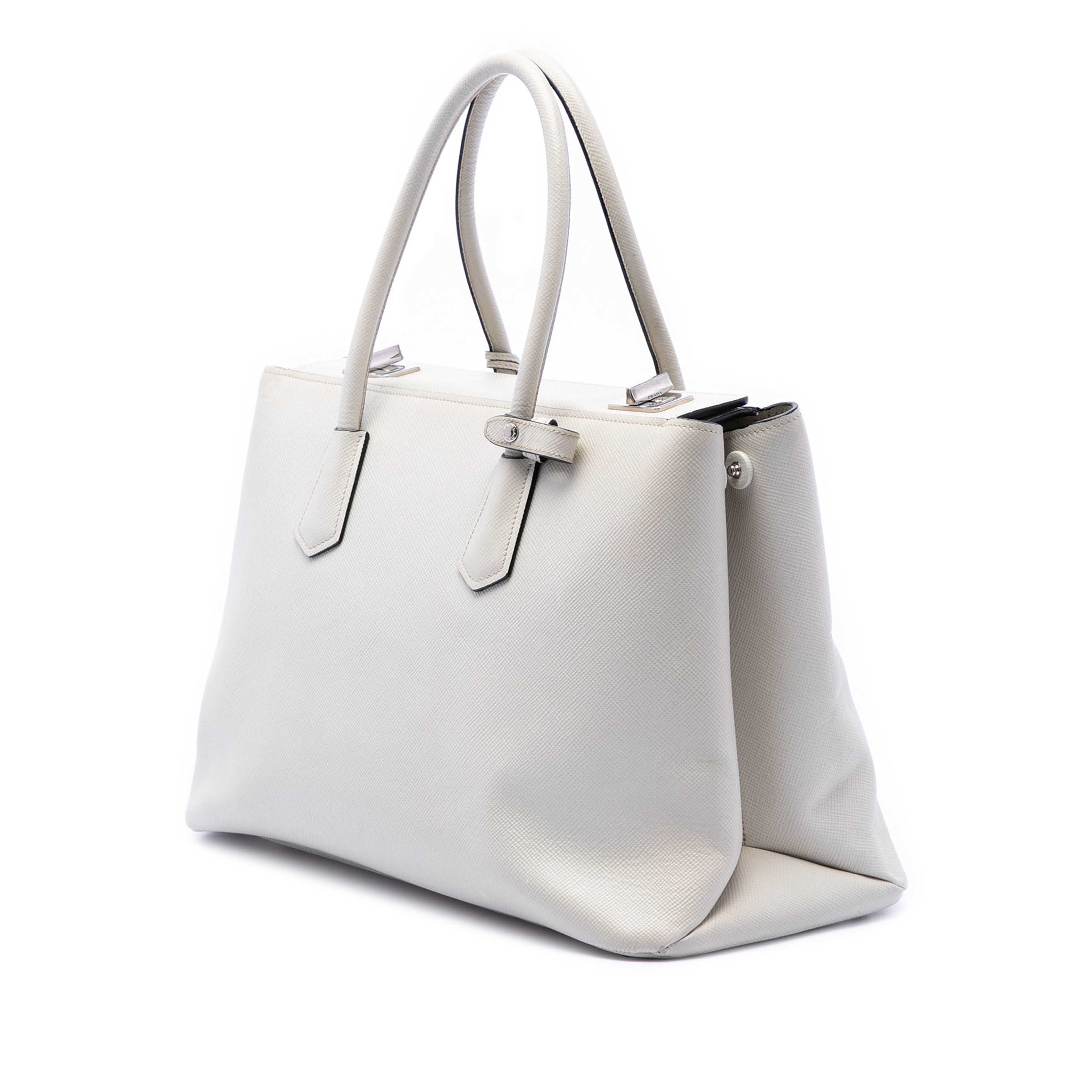Prada Saffiano Cuir Turnlock Twin Satchel, från Luxclusif, i färgen ivory. Klicka för att öppna bilden i stort format