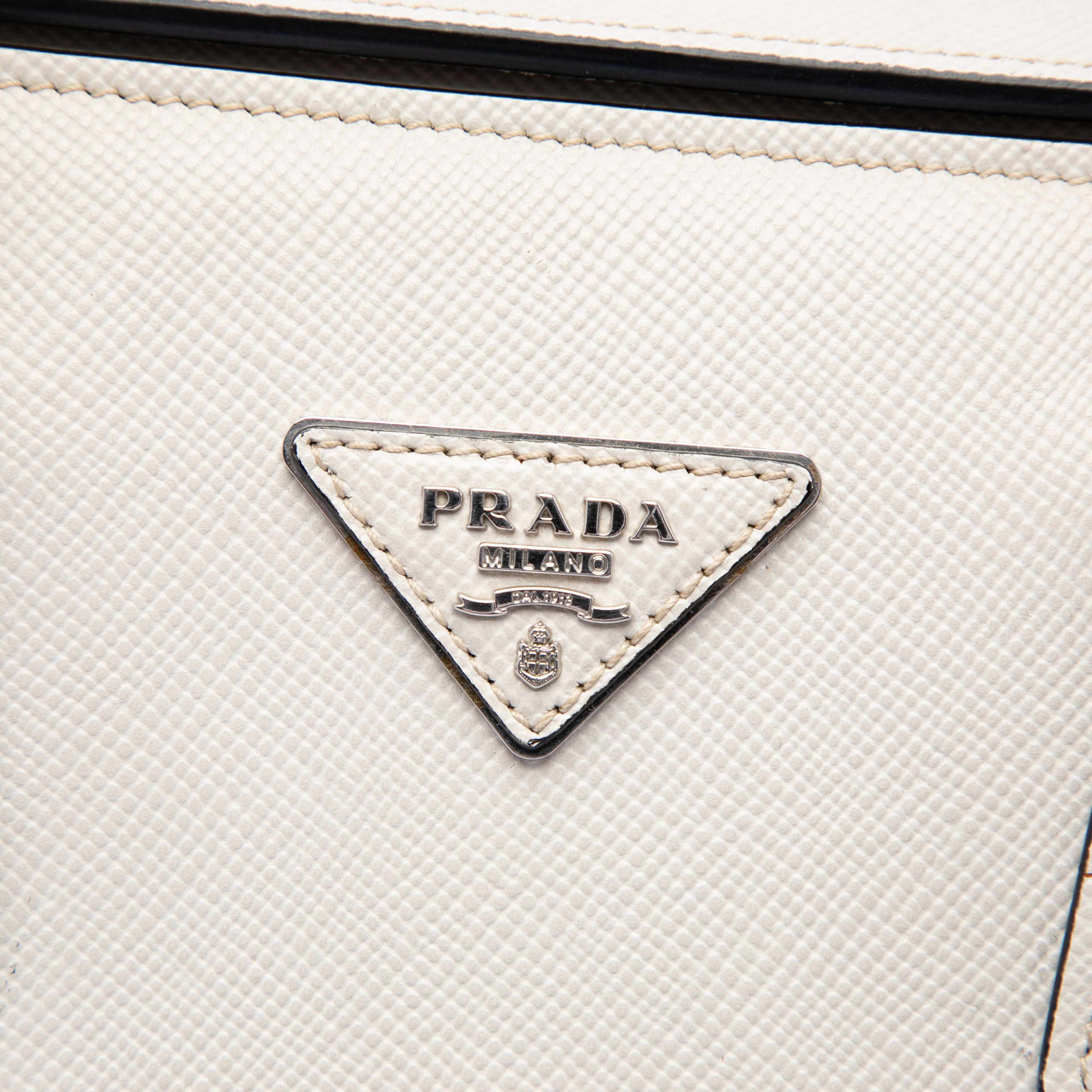 Prada Saffiano Cuir Turnlock Twin Satchel, från Luxclusif, i färgen ivory. Klicka för att öppna bilden i stort format
