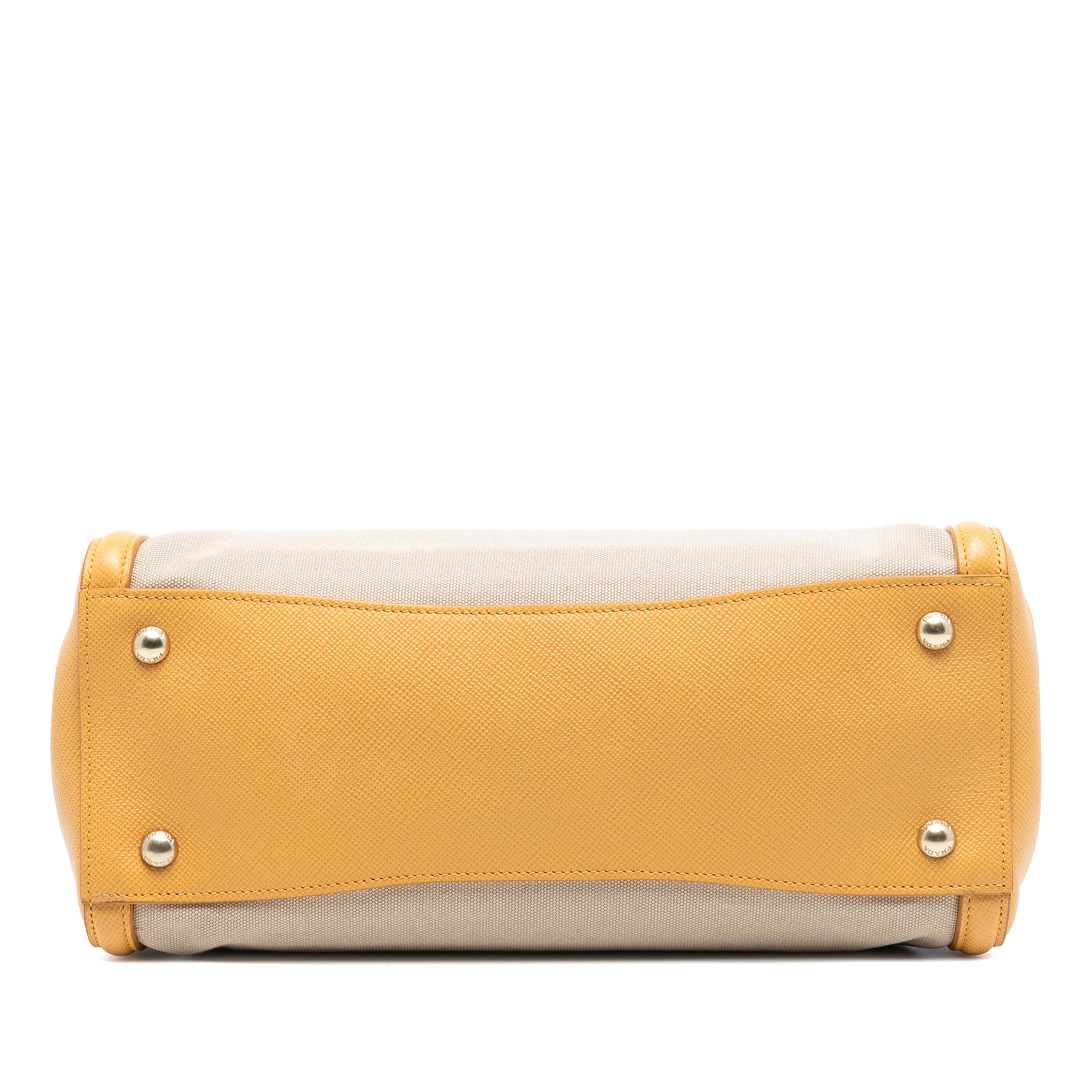 Prada Saffiano Cuir Trimmed Canapa Satchel, från Luxclusif, i färgen beige. Klicka för att öppna bilden i stort format