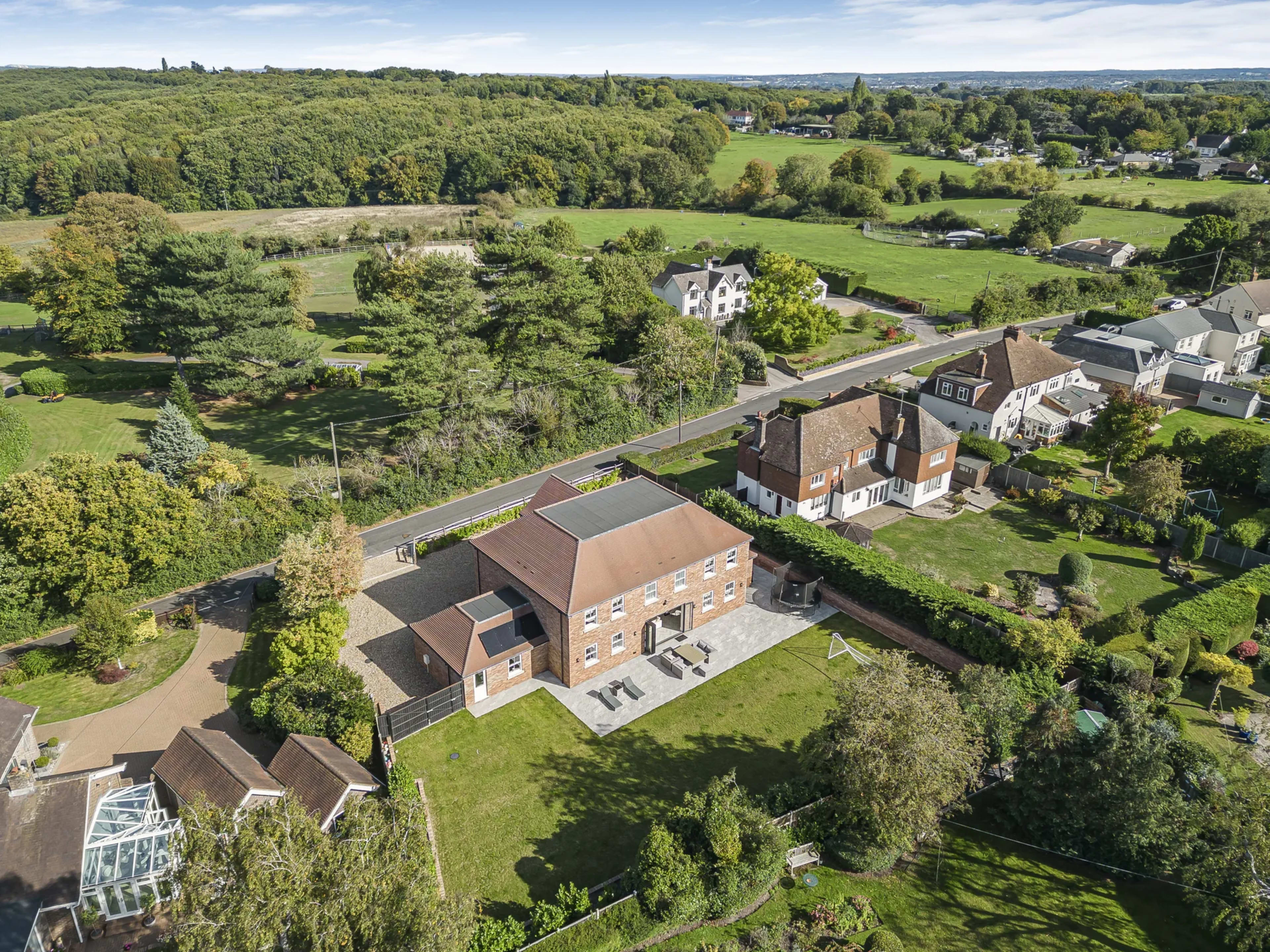 Aerial drone view of a residential property and surrounding plot