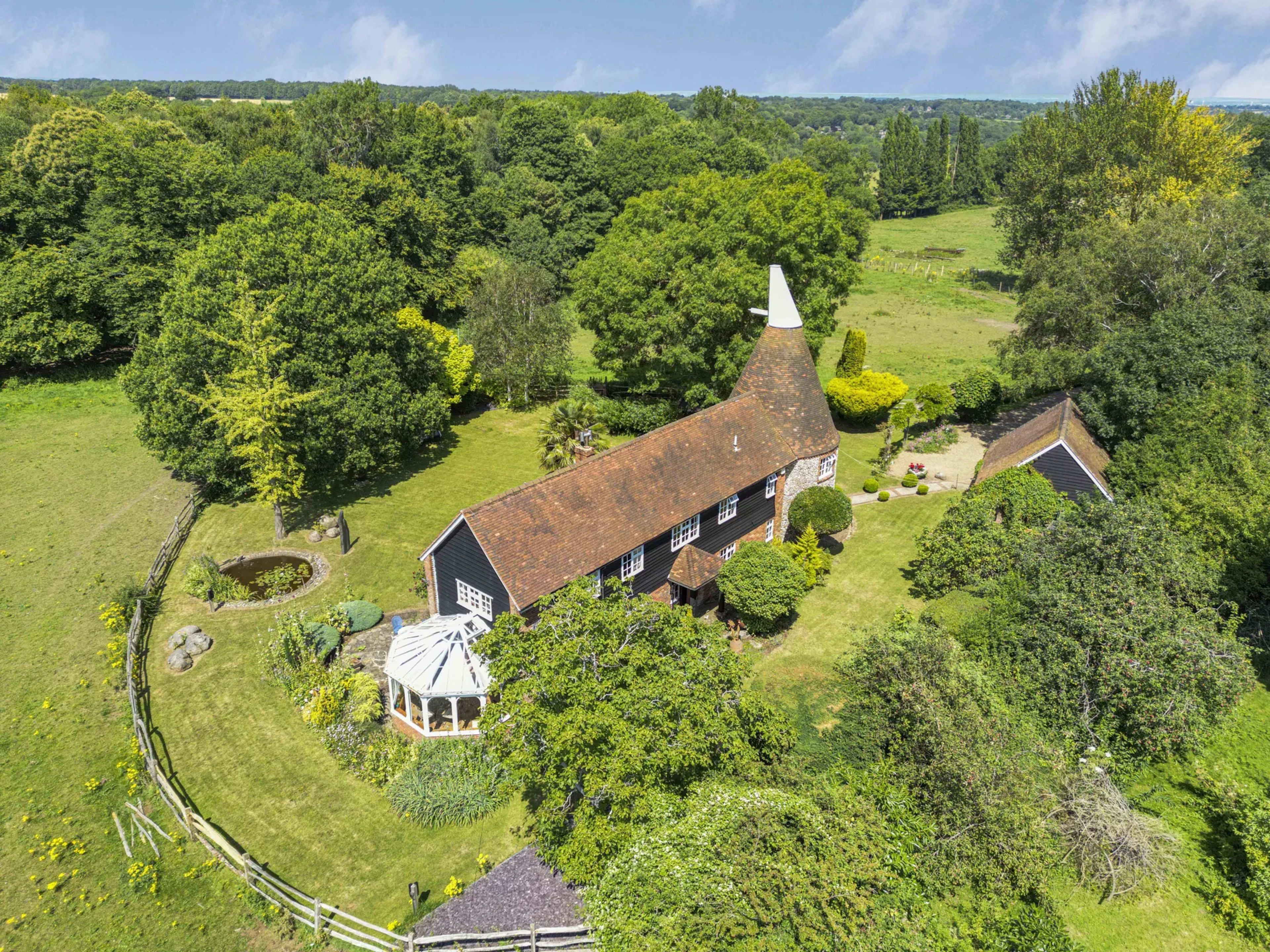 Aerial drone view of a residential property and surrounding plot