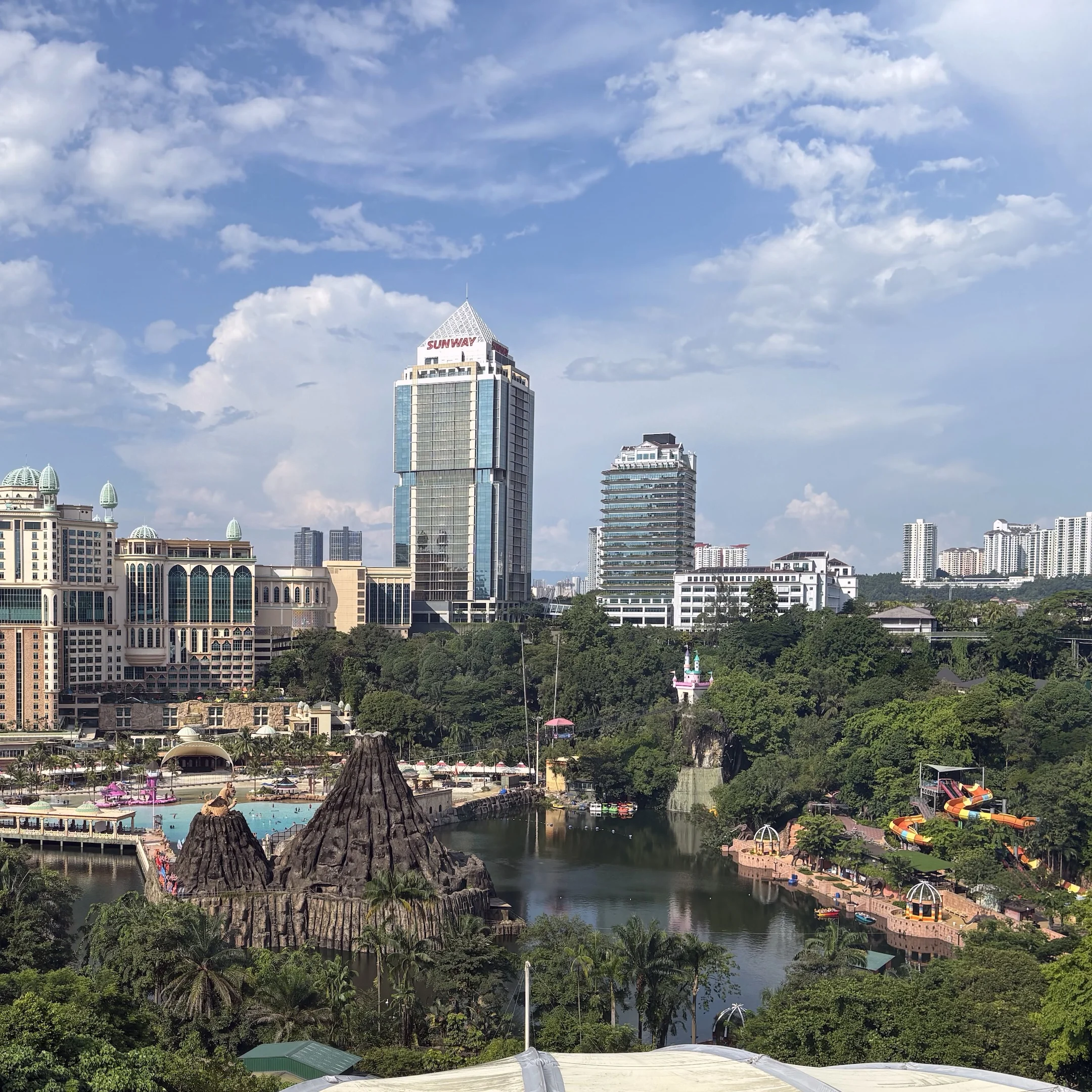 A view of a city with a lake and buildings.