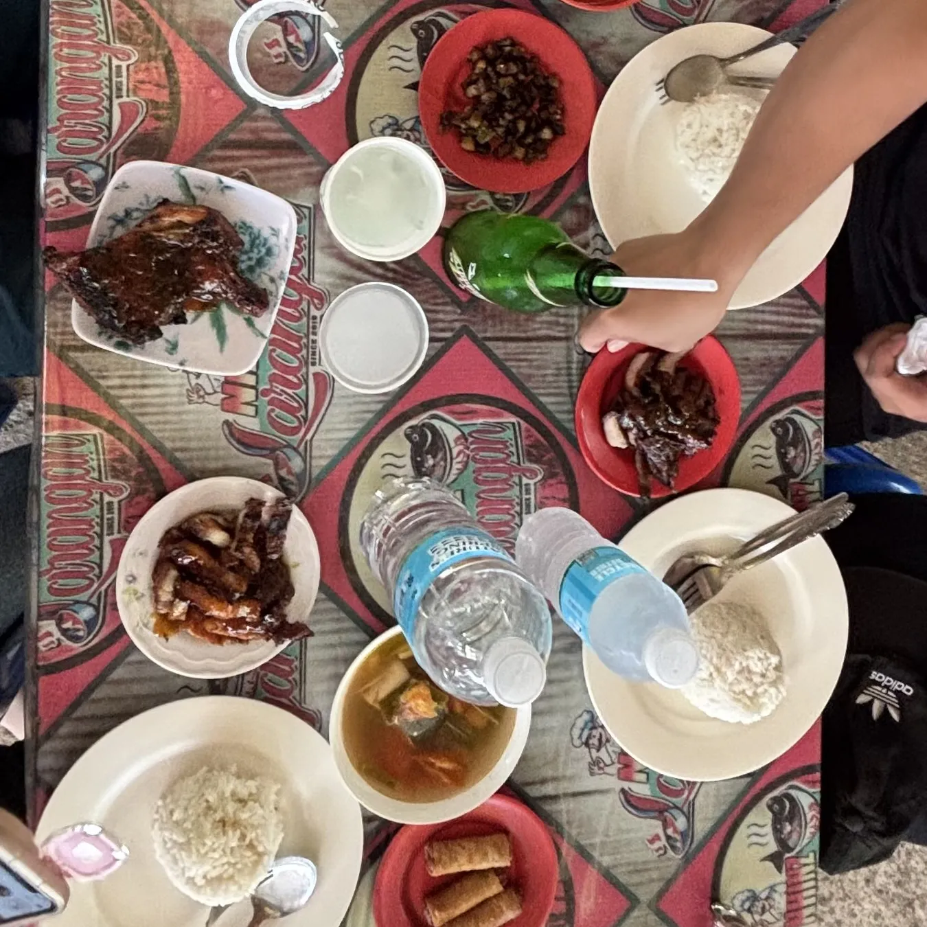 A table with plates of food and drinks.
