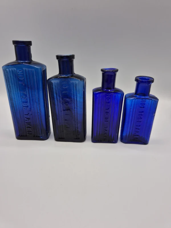 4 Blue Oblong Poison Bottles