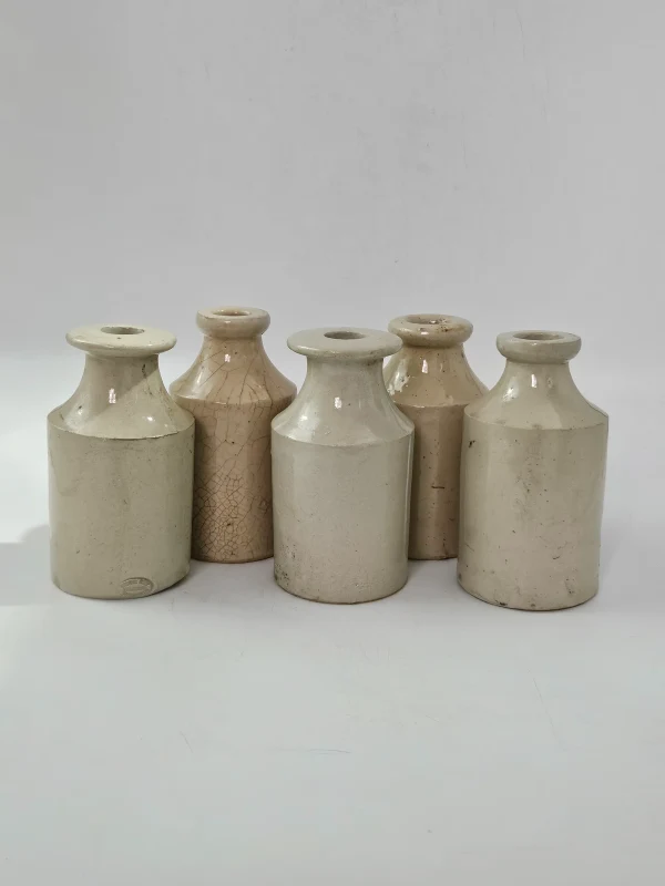 5 WHITE STONEWARE BOTTLES