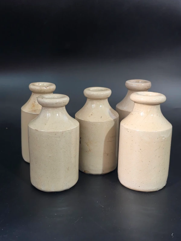 5 WHITE STONEWARE BOTTLES