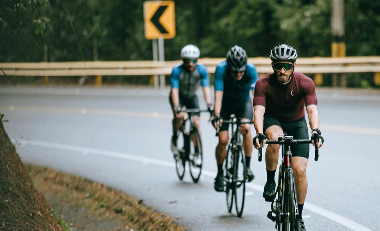 Group of cyclists riding together on an open road