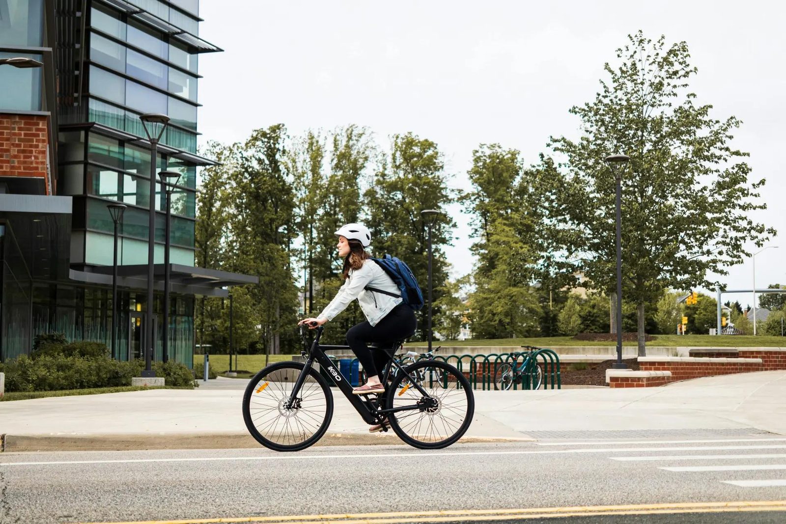Delivery rider crossing a city street on an e-bike