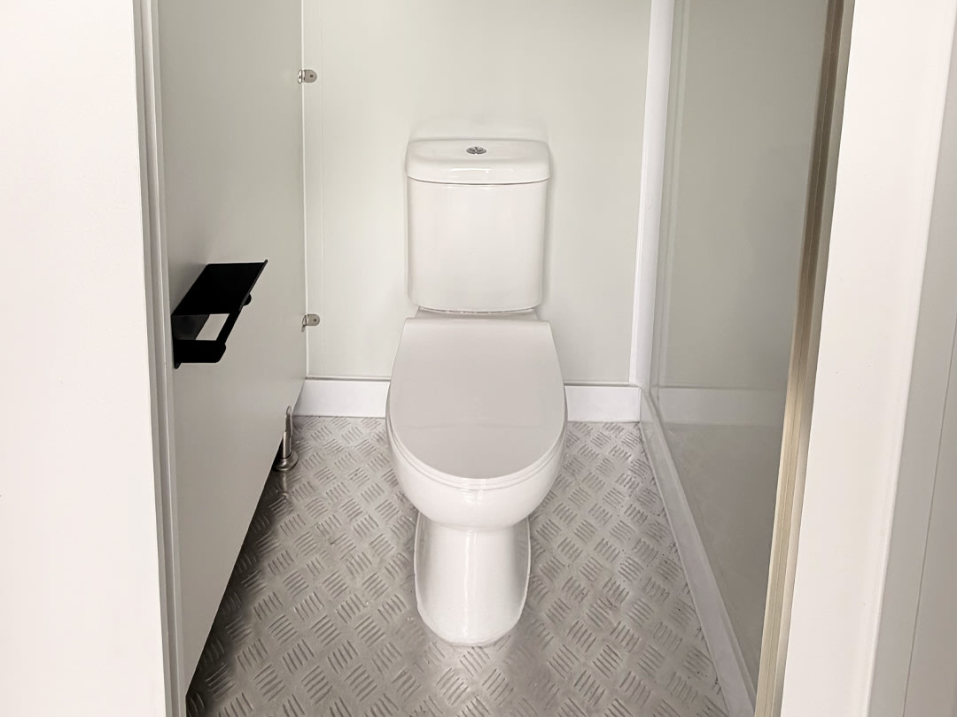 Toilet cubicle interior in an ablution block with anti-slip checker-plate flooring