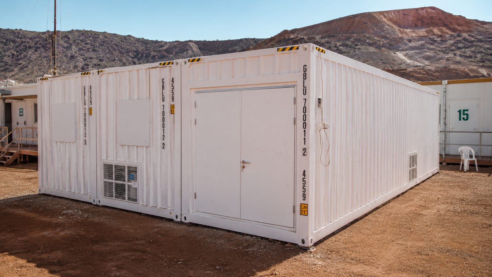 Exterior of a white container mess building at a remote mining camp