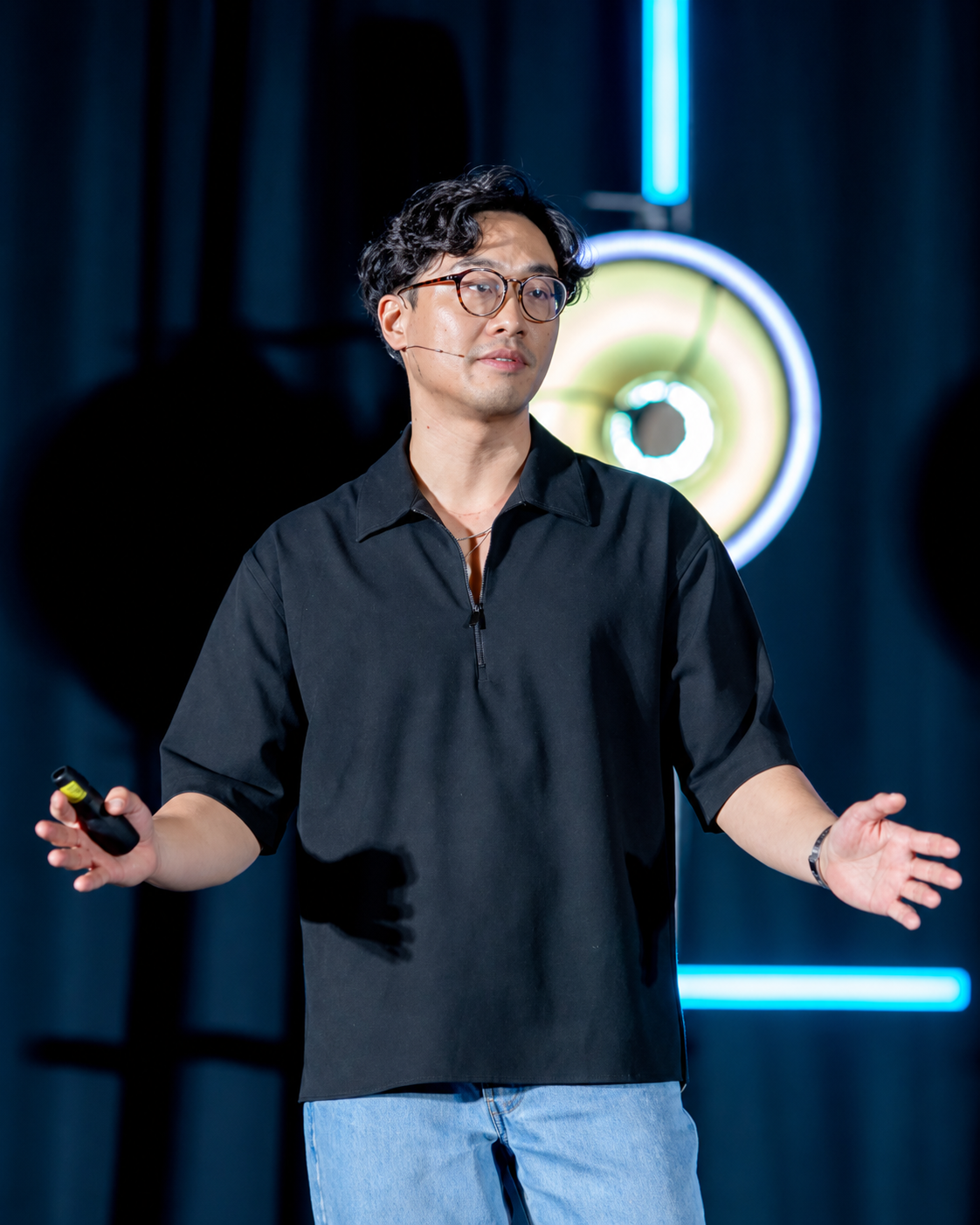 Vincent Chan speaking on stage about money and investing