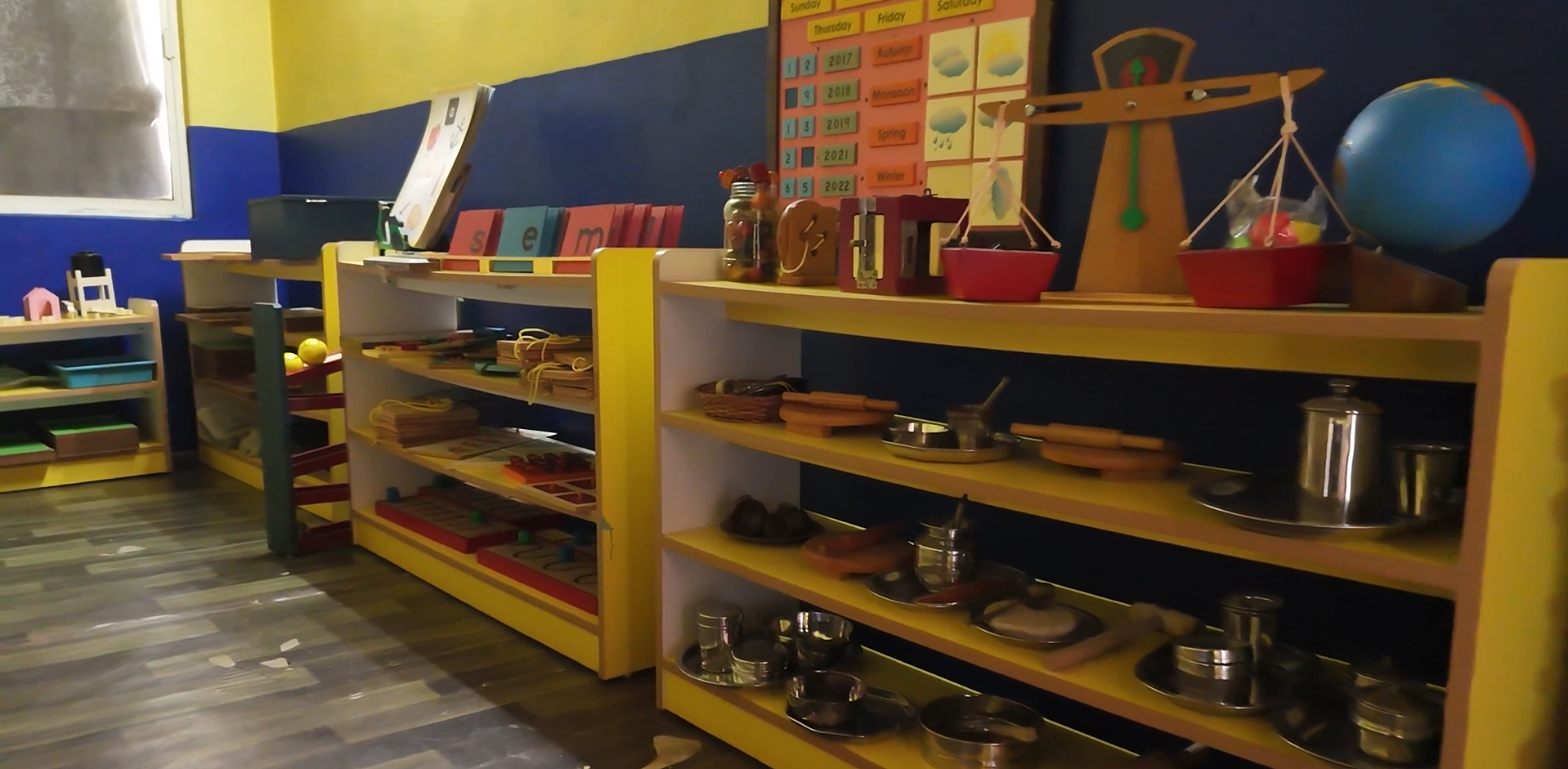 A child happily painting with bright colors in an art class.