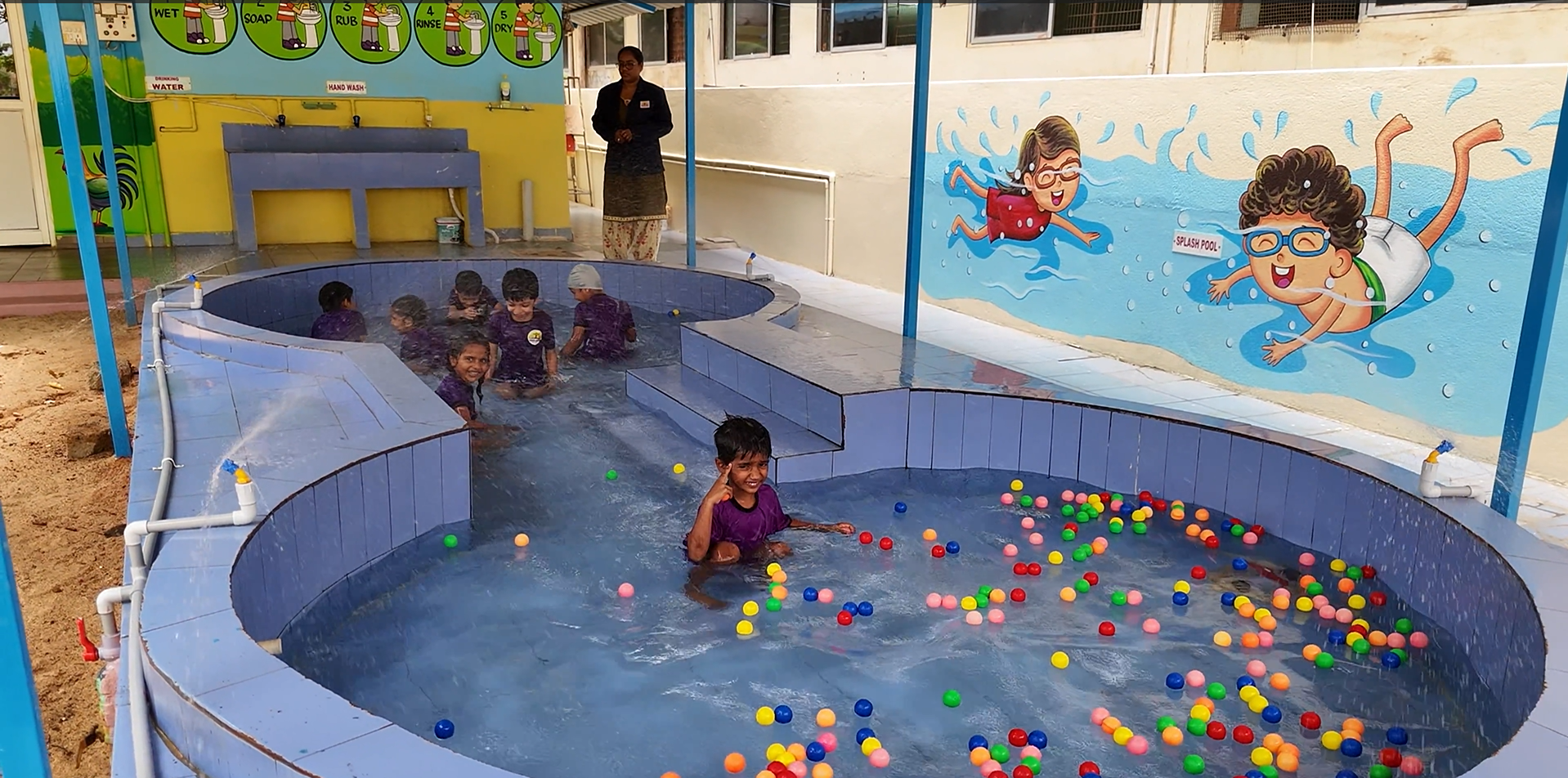 A speaker addressing a large audience during a seminar or assembly.
