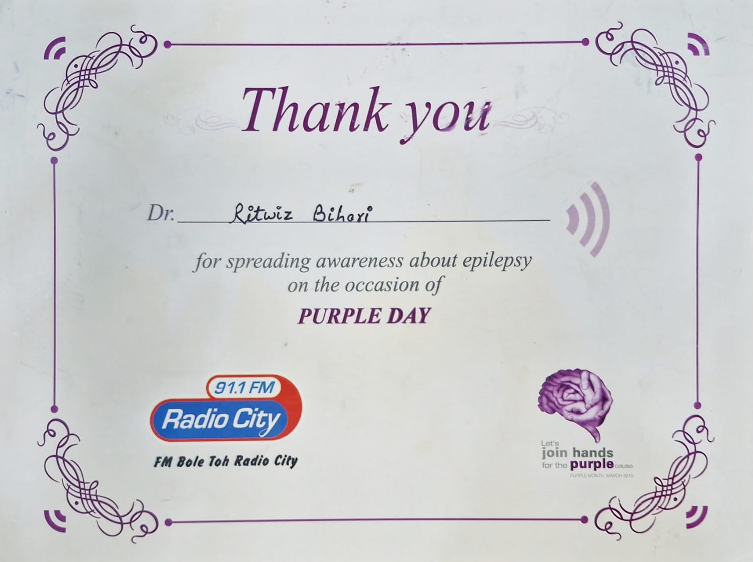 Purple Day epilepsy awareness appreciation certificate presented to Dr. Ritwiz Bihari by Radio City 91.1 FM