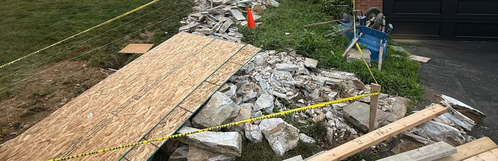 A cleanout in progress — debris piled and staged for haul-away by Forging Solutions