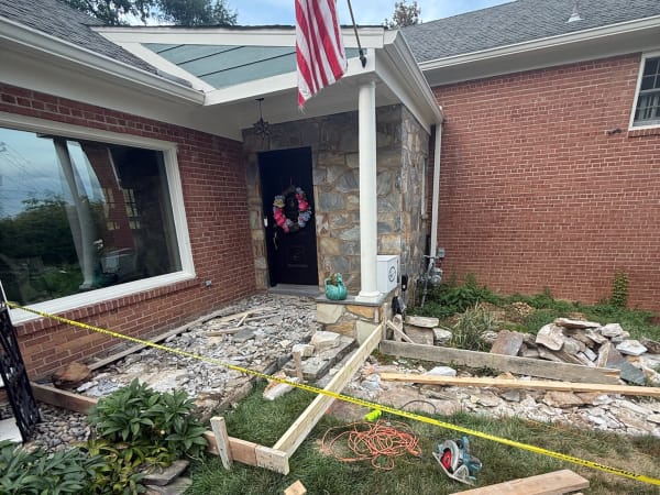 Front porch demolition in progress, stone removed and staged