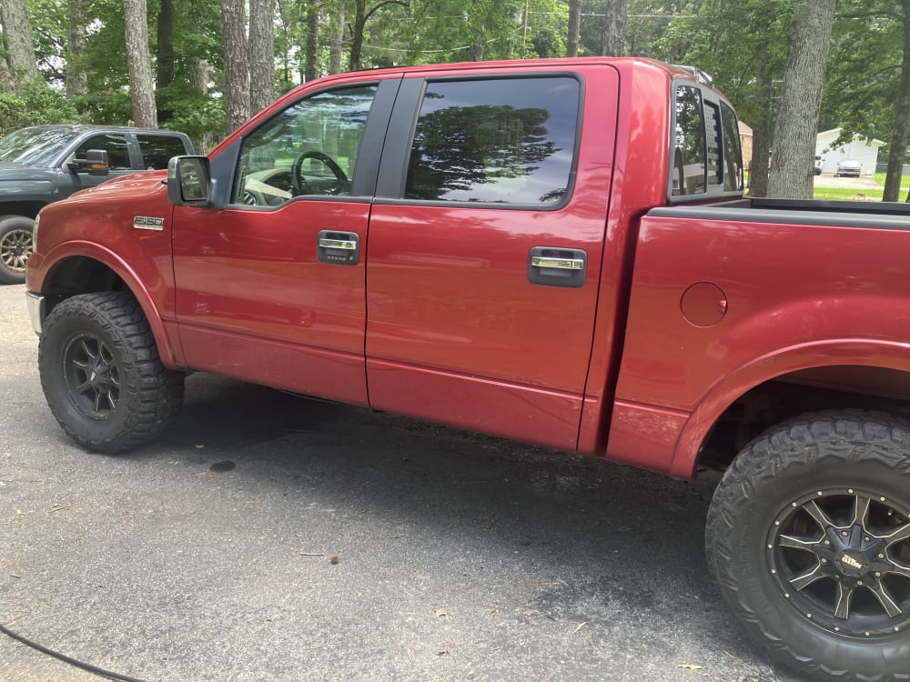 The same red F-150 cleaned and finished in the driveway after a mobile detail