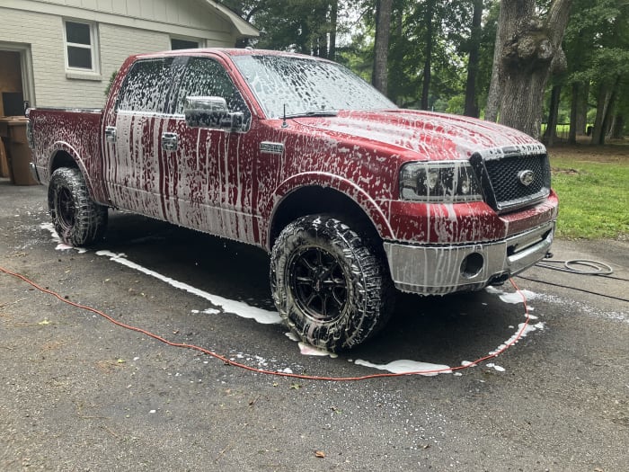 The same F-150 covered in wash foam during the detail