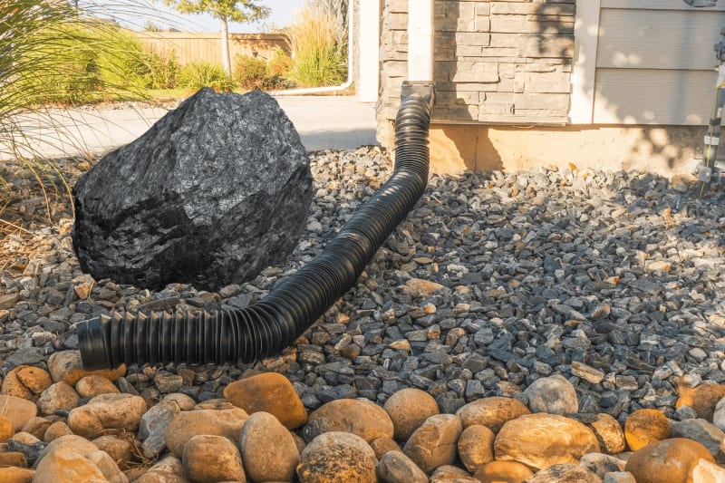 Downspout extension routing water away from foundation