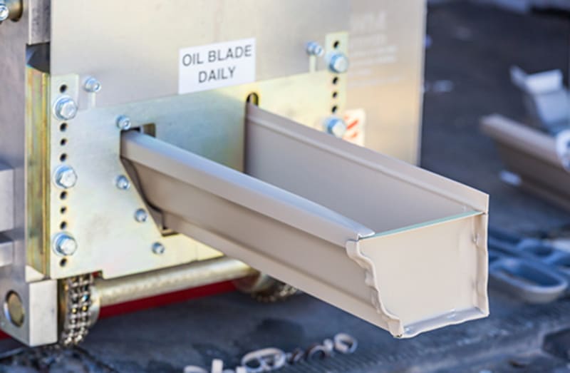 Seamless gutter machine fabricating custom gutters on-site