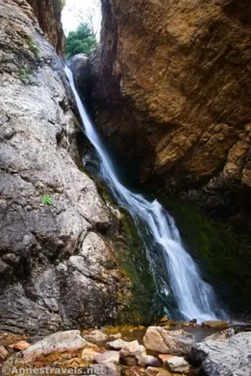 Hidden Falls flows down between who large rocks in Big Cottonwood Canyon, Utah