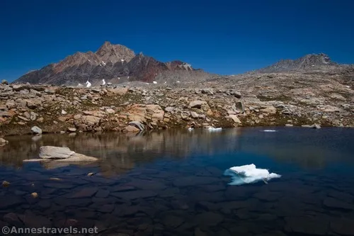 Humphreys Peak and a small pond with an iceberg above Piute Pass, Inyo National Forest, California