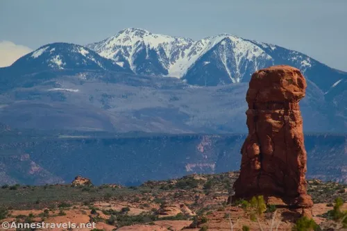 A rocky spire and the La Sal Mountains from the Balanced Rock Trail, Arches National Park, Utah