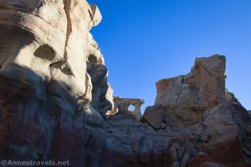 Hiking downcanyon toward "Tuscan Pillar Arch" in Resurrection Canyon, Glen Canyon National Recreation Area, Utah