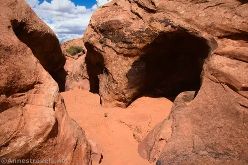 An early slot section with a hole in the wall of Willow Springs Canyon, Arches National Park, Utah