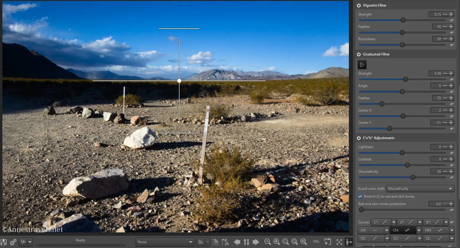 Using the Graduated Filter tab (see the arms you can move around to position the filter on the picture?) in RawTherapee