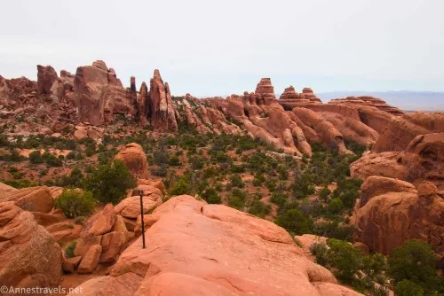 Hiking along the top of a fin in Devils Garden, Arches National Park, Utah